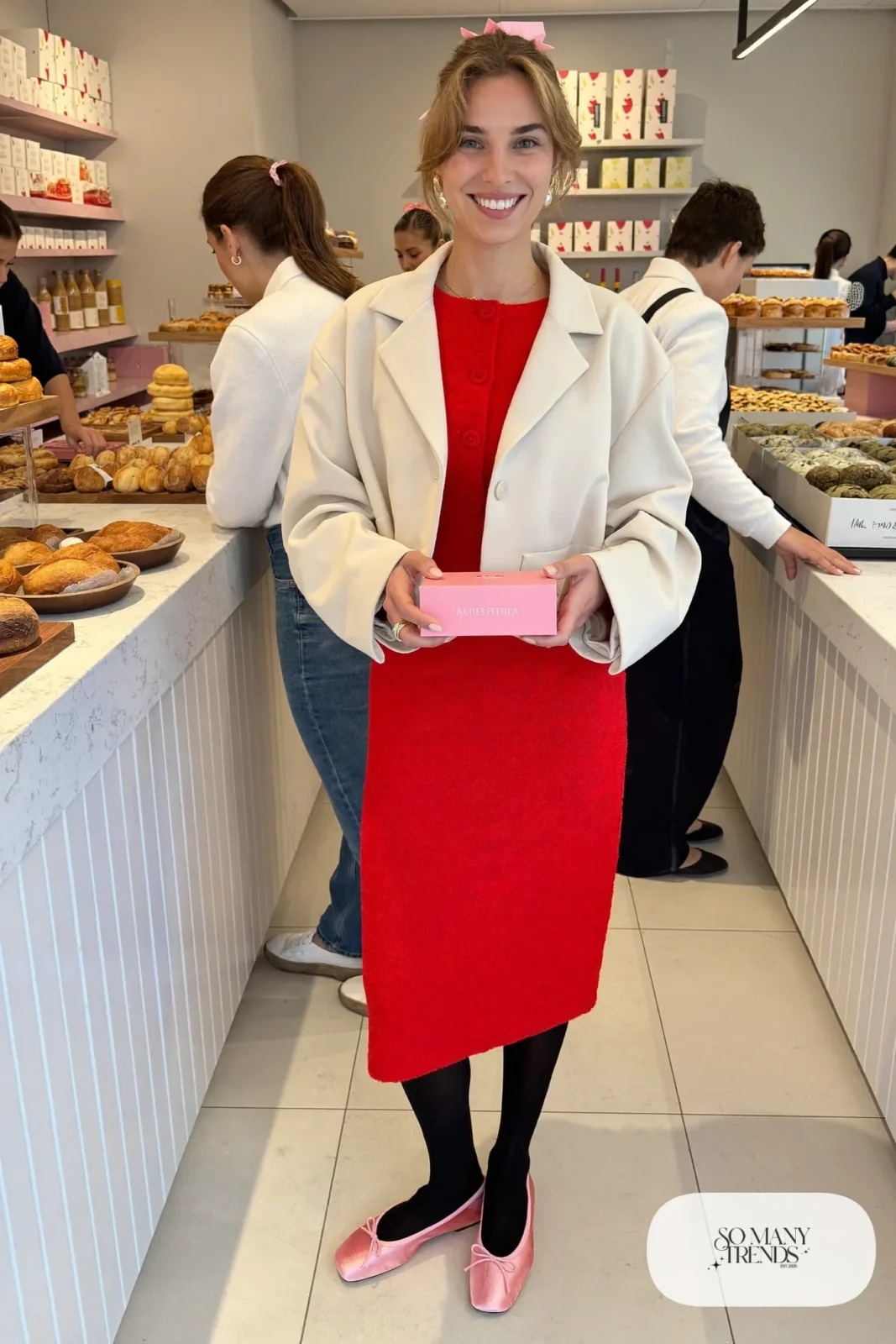 Woman in a red button-up knit midi dress, cream cropped jacket, pink ballet flats and a pink ribbon in her hair, outfit 9