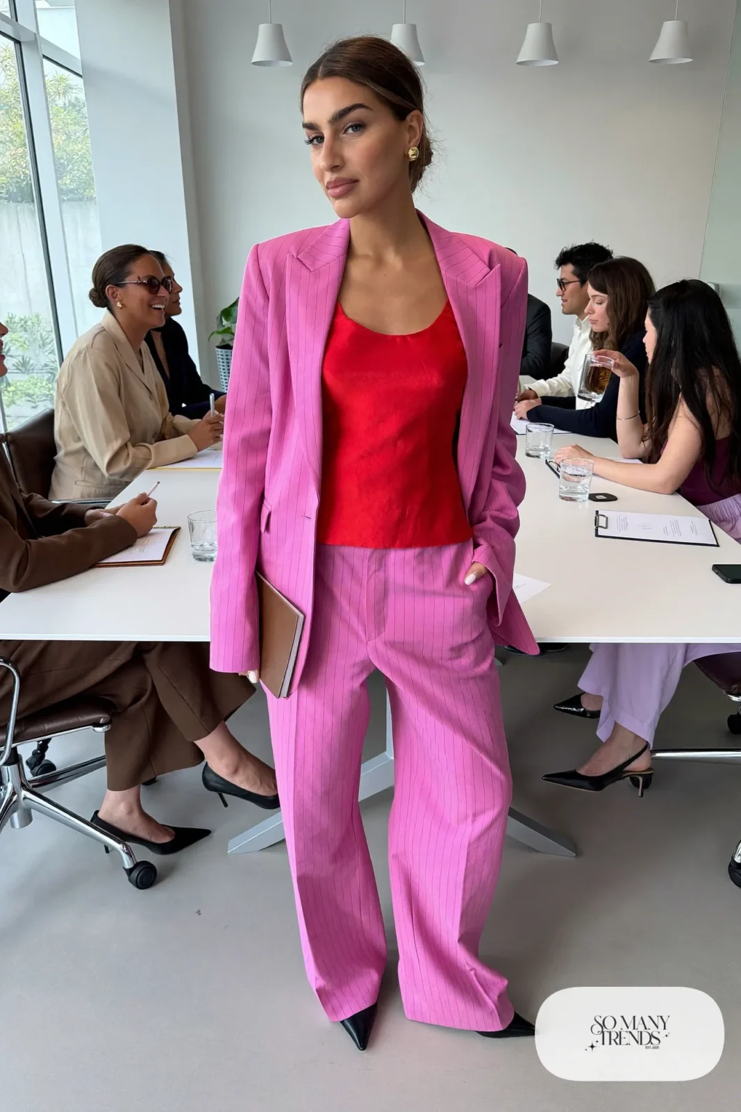 Woman in a pink pinstripe blazer and wide-leg pants with a red silk camisole and black pointed pumps, outfit 12