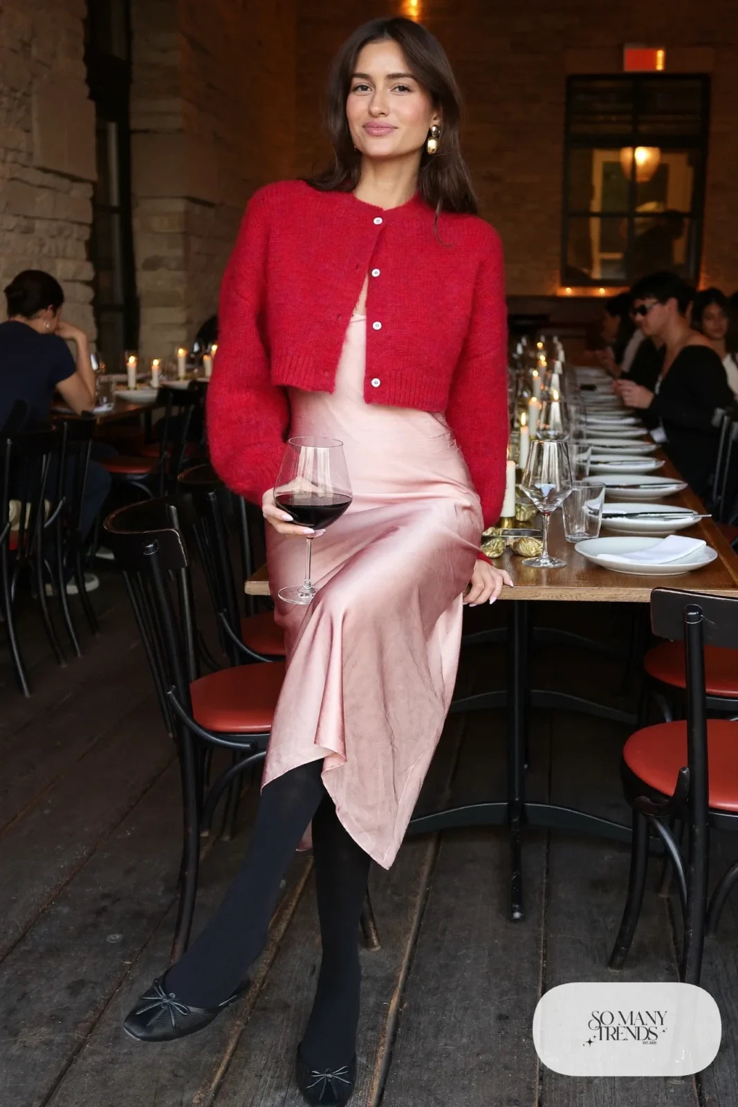 Woman in a cherry red cropped cardigan over a blush slip midi dress with sheer tights and black flats, outfit 17