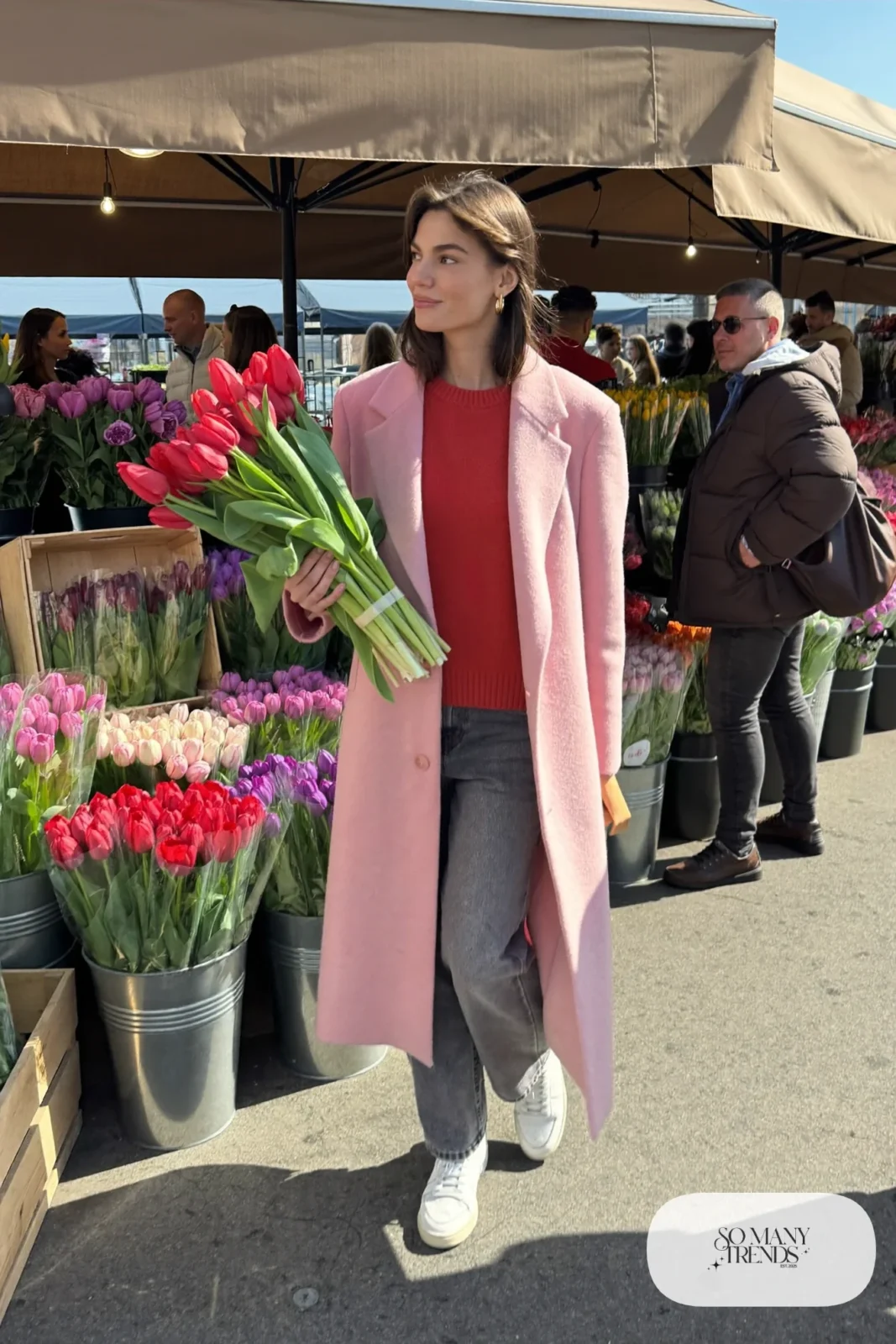 Woman in a blush pink overcoat, red knit sweater, gray straight jeans and white sneakers, outfit 31