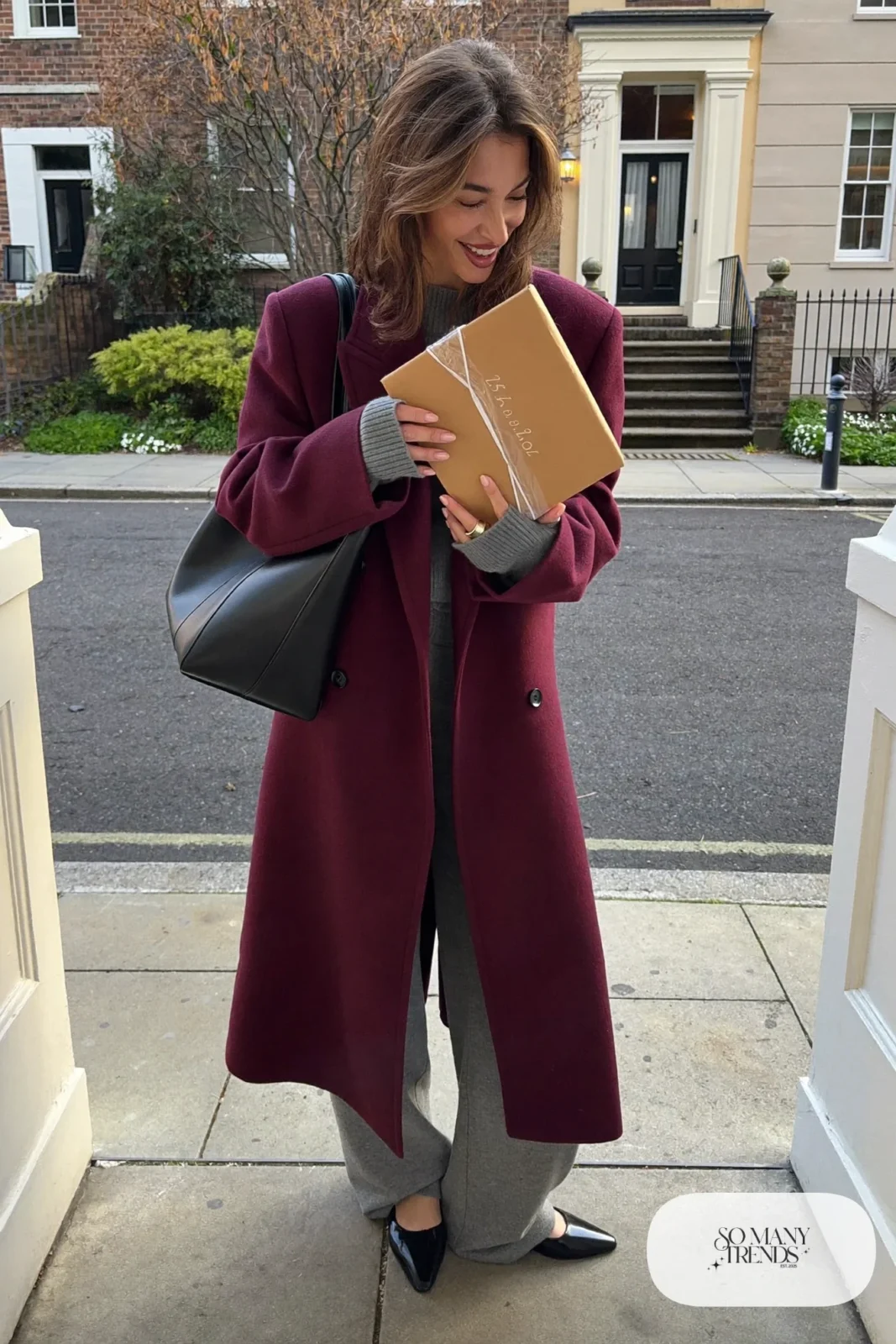 Woman in a long burgundy wool coat over a gray knit sweater and matching wide-leg knit pants with black flats, outfit 17