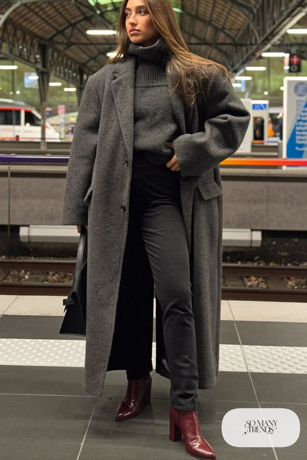Woman in heather gray wool coat, charcoal knit, black pants and oxblood leather boots, outfit 14