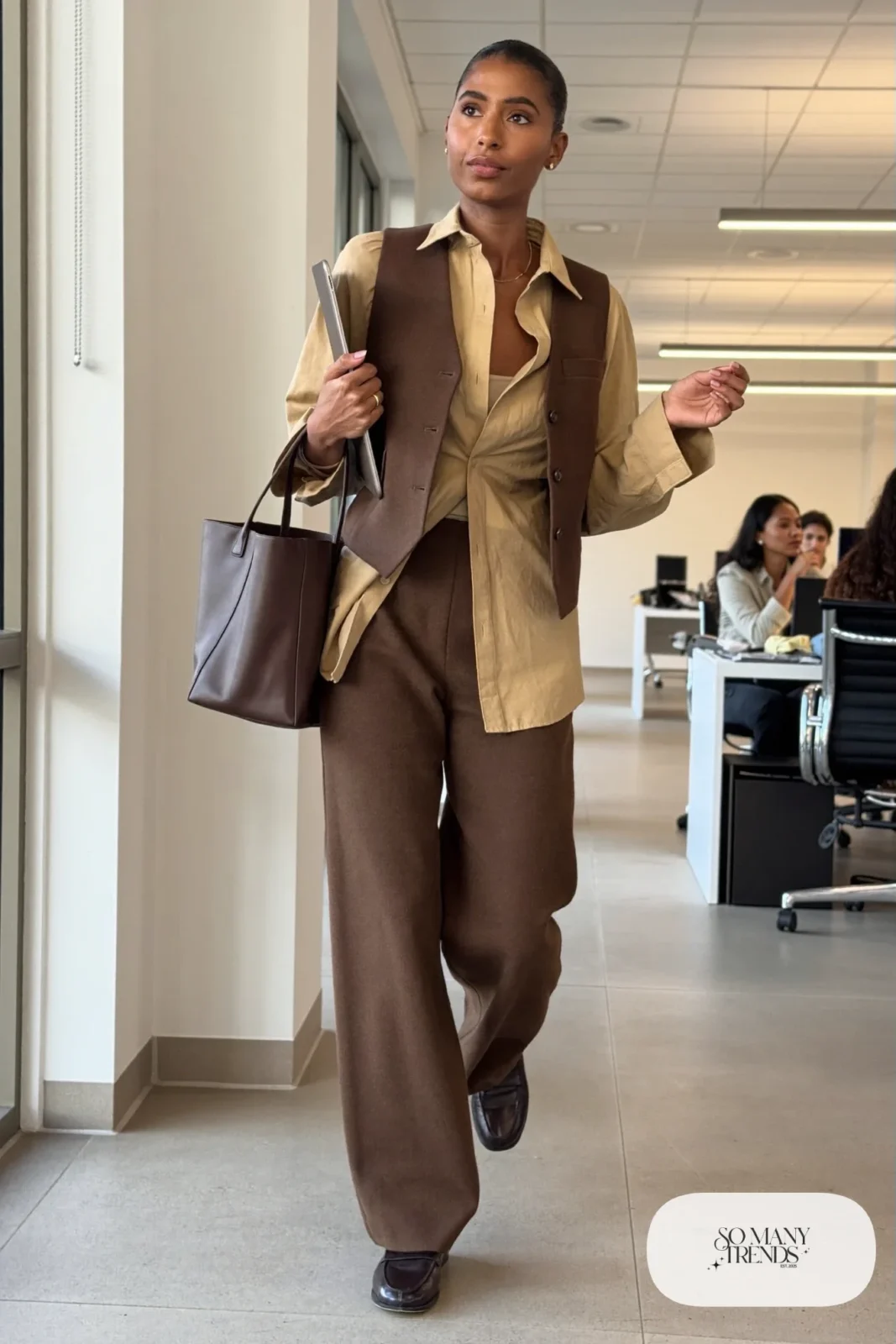 Woman in tan poplin shirt, mocha tailored vest, espresso wide-leg wool pants and brown leather loafers, outfit 4