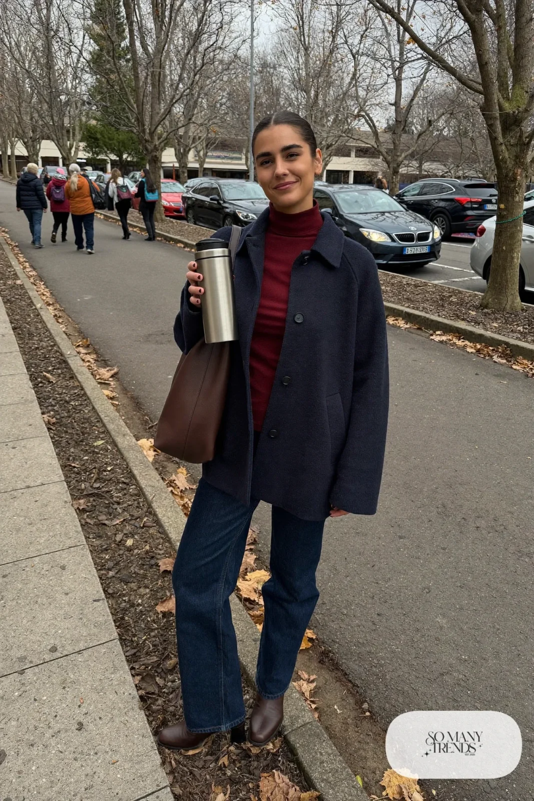 Woman in navy wool coat, oxblood turtleneck, dark blue jeans and brown leather boots, outfit 10