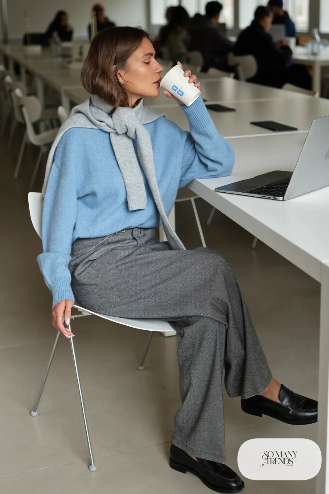 Woman in powder blue knit sweater, gray flannel wide-leg pants, gray wool scarf and black loafers, outfit 20