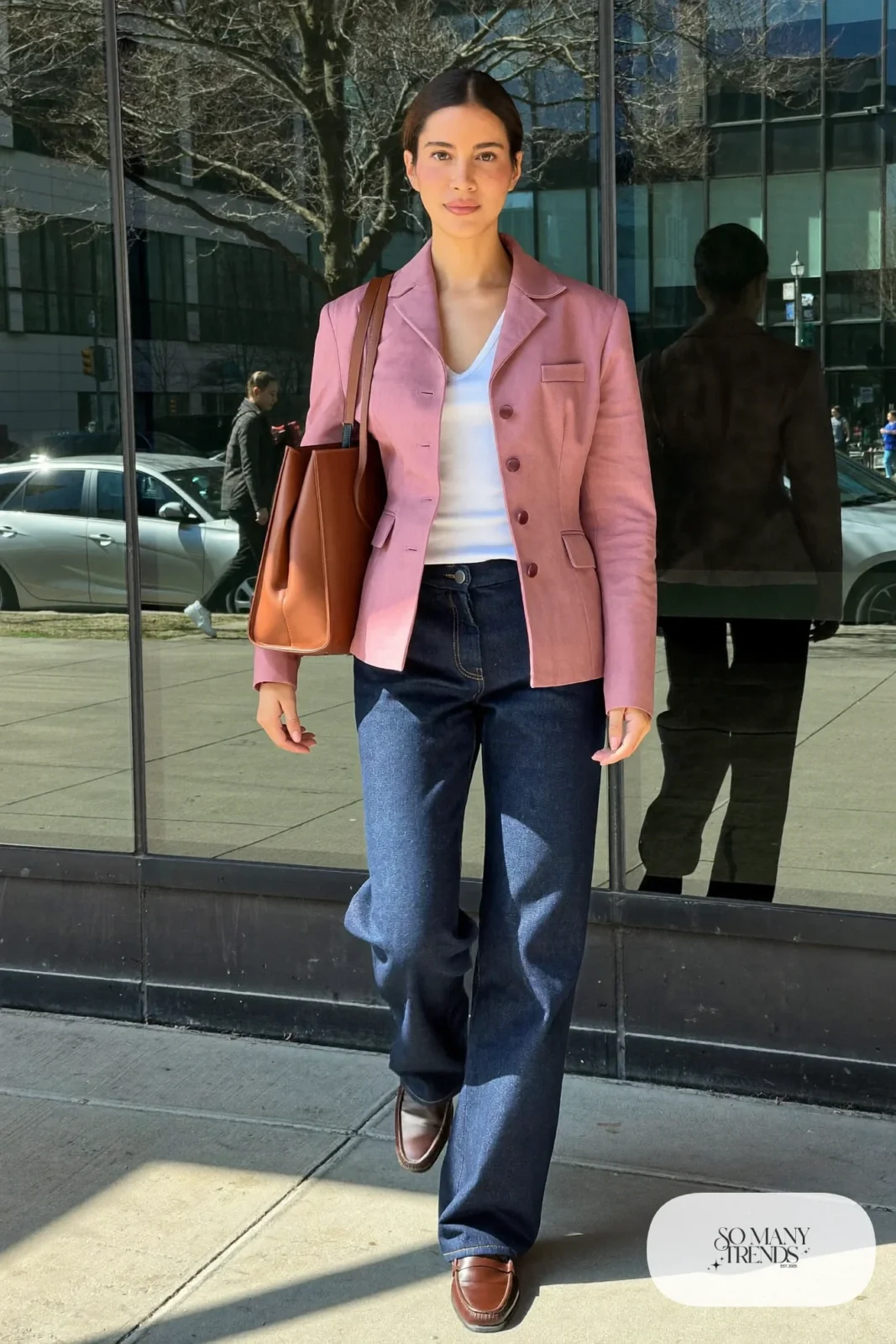 Woman in dark barrel jeans, fitted dusty pink blazer, white tee and brown leather loafers, look 3