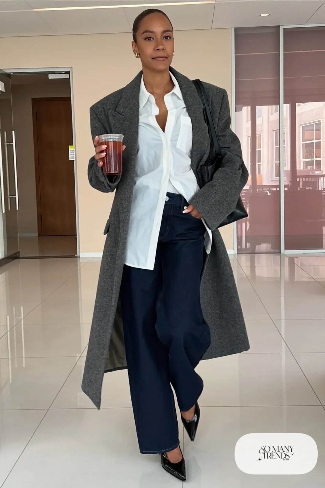 Woman in dark wide-leg jeans, gray tailored coat, white shirt and black block-heel pumps, look 7