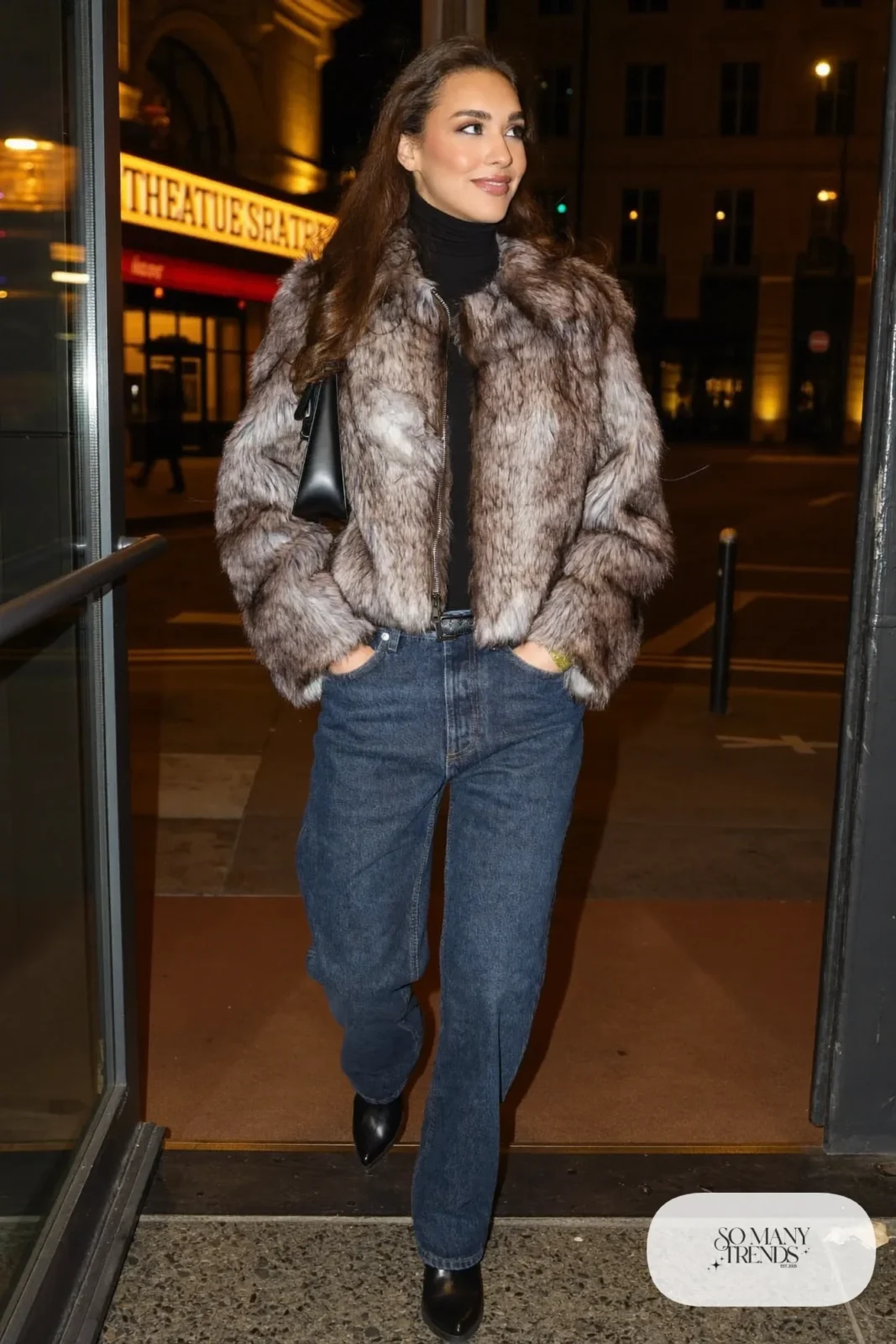 Woman in straight indigo jeans, cropped gray faux fur coat, black turtleneck and black boots, look 26