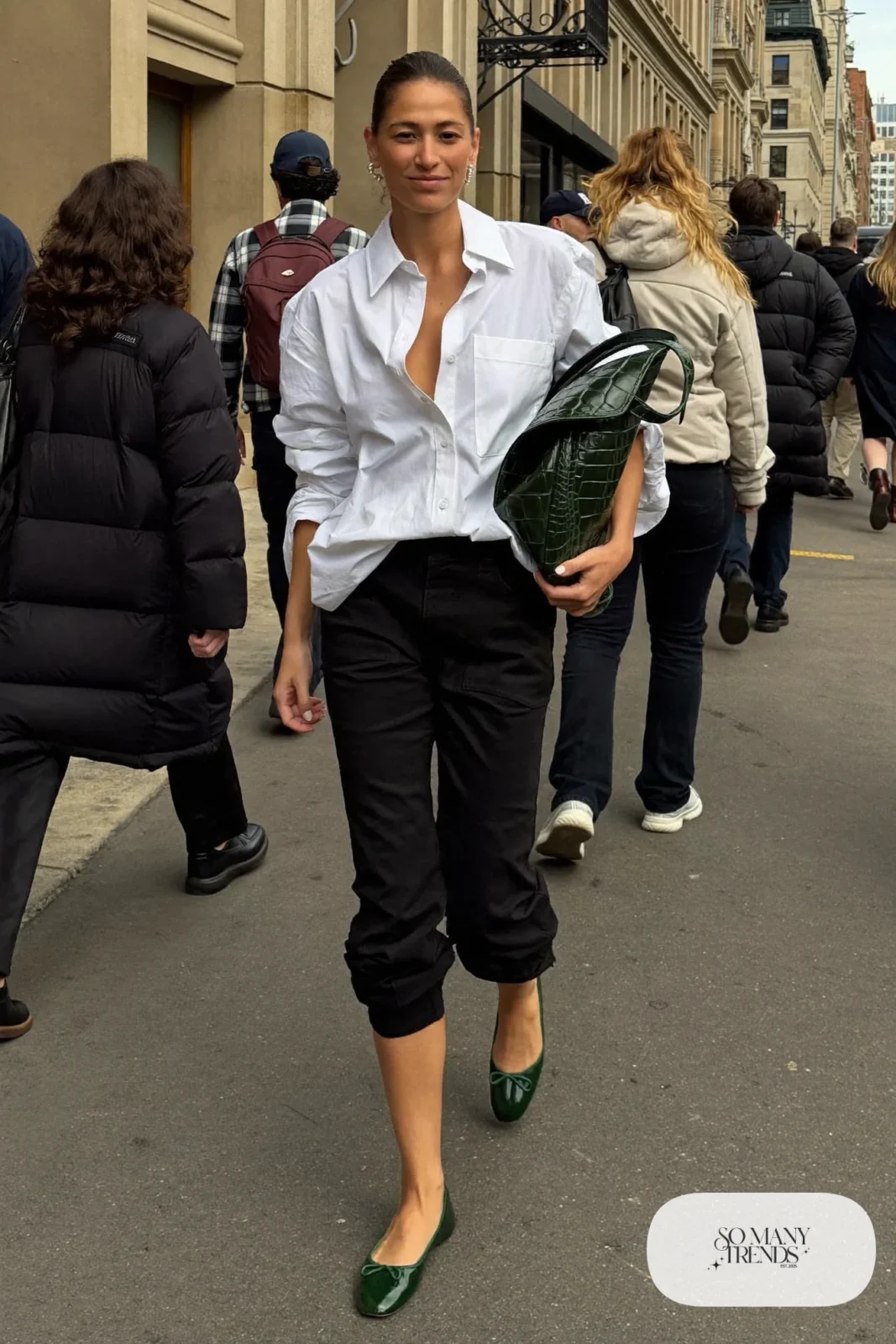 Woman in an oversized white shirt, black barrel-leg pants, dark green flats and a structured tote, outfit 3