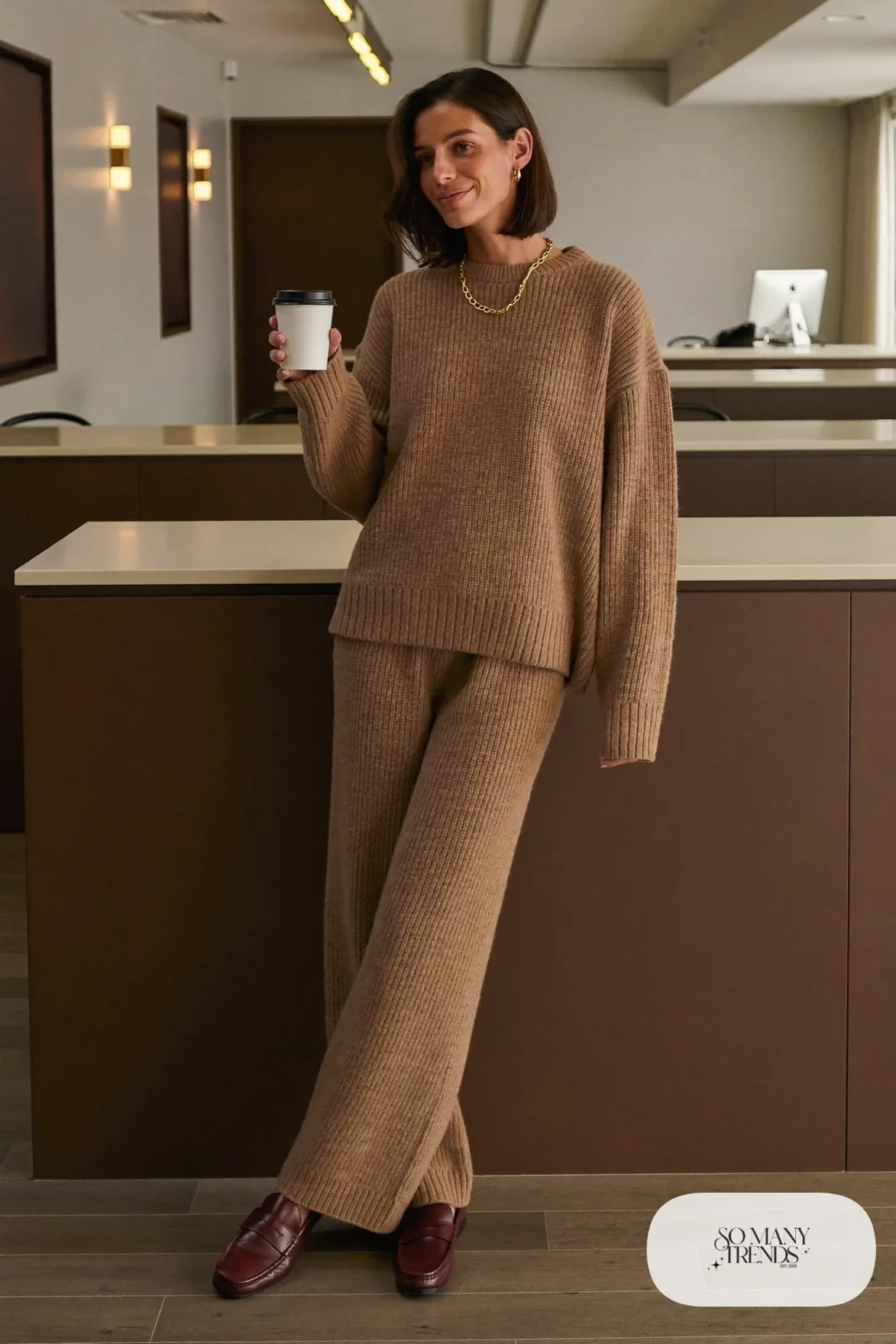 Woman in a mocha ribbed knit sweater and matching wide-leg knit pants with brown loafers and a gold necklace, outfit 7