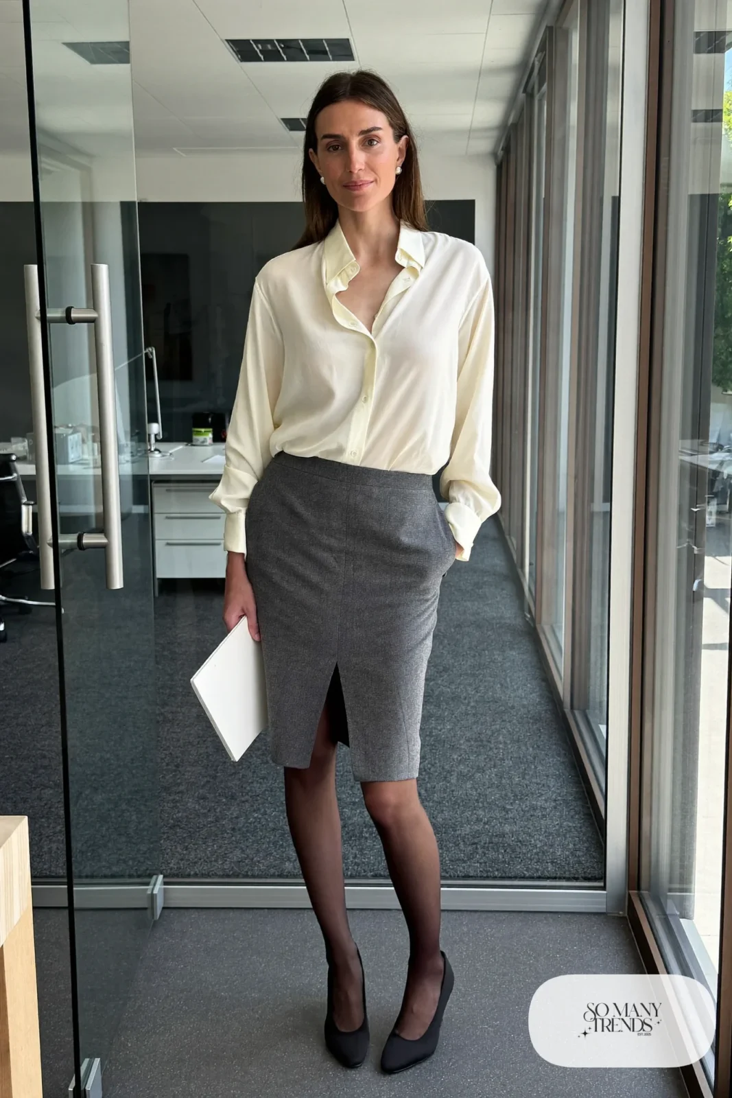 Woman in a cream silk blouse, slate gray pencil skirt, sheer tights and black pumps, outfit 13