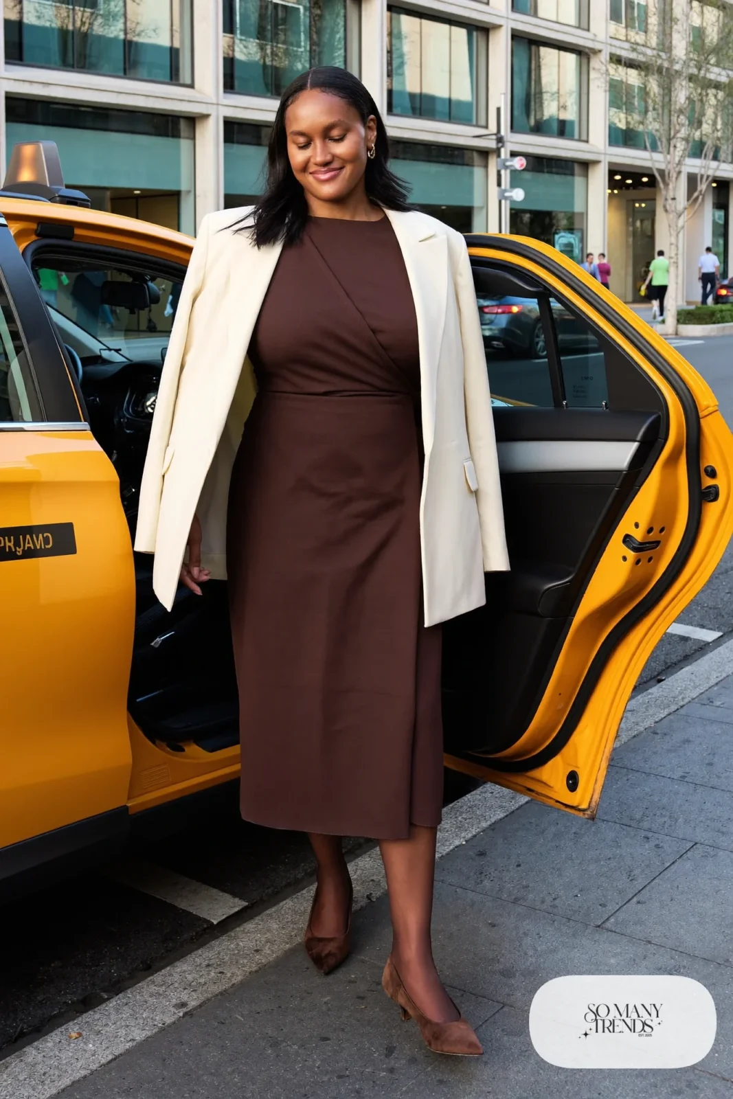 Woman in a chocolate brown wrap midi dress with a cream blazer, sheer tights and kitten heels, outfit 15