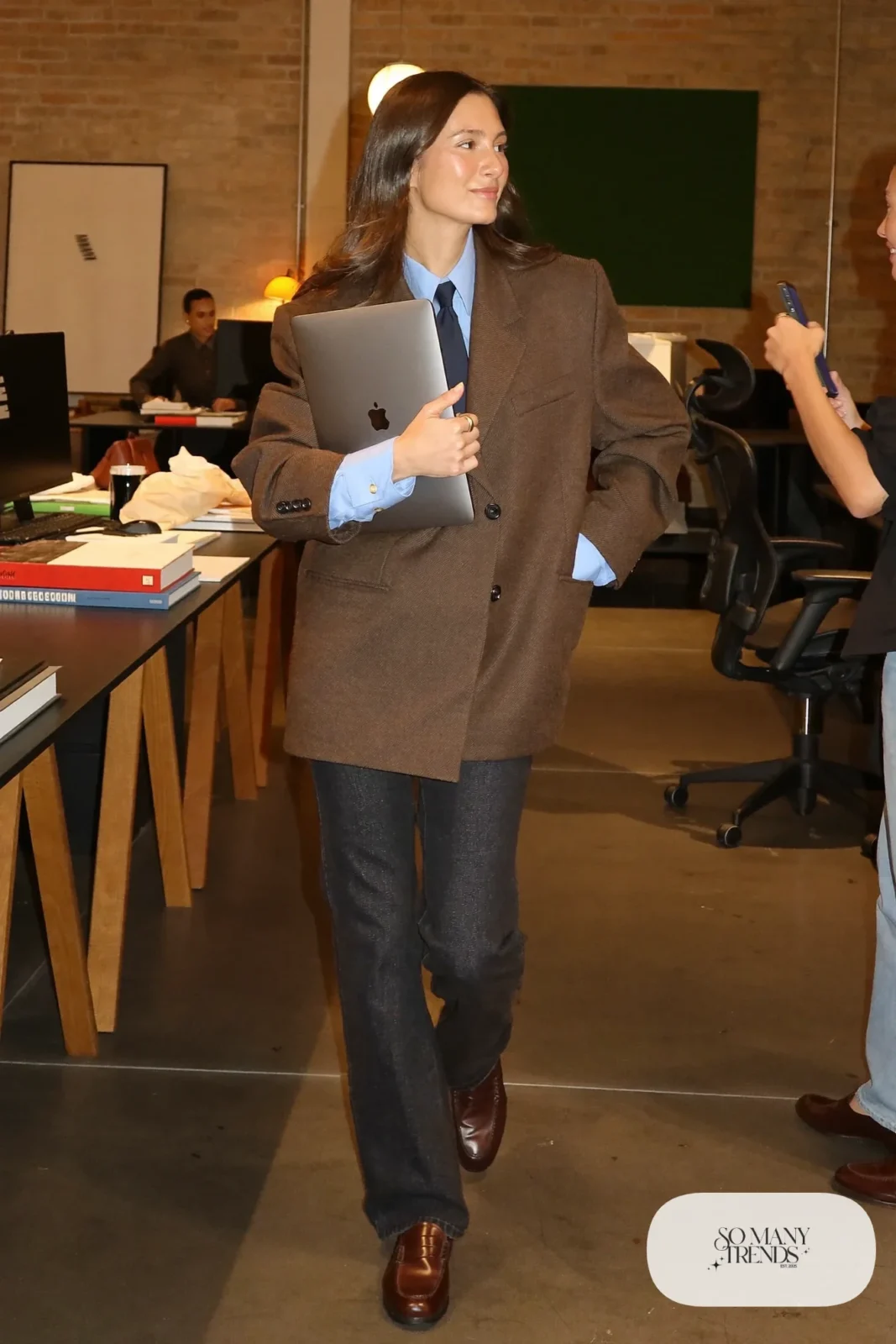Woman in a mocha oversized blazer, sky blue shirt with tie, dark straight jeans and loafers, outfit 23