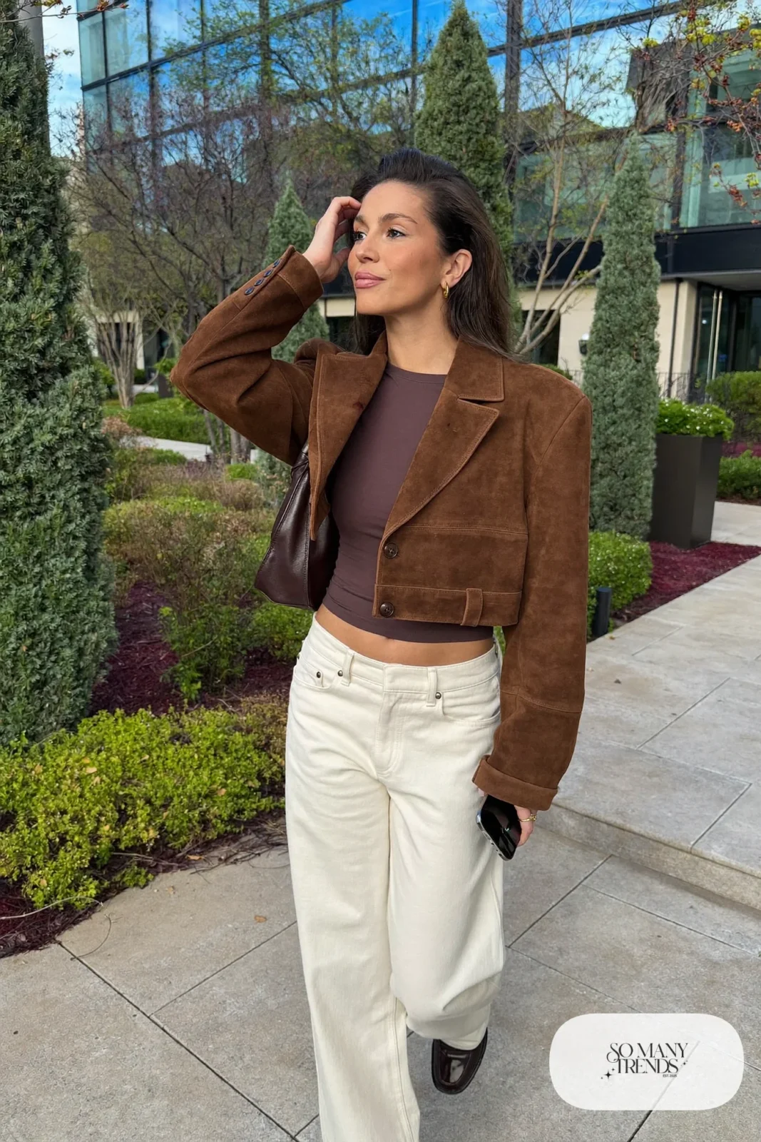 Woman in a chocolate suede jacket, cream wide-leg pants, fitted knit and loafers, outfit 28