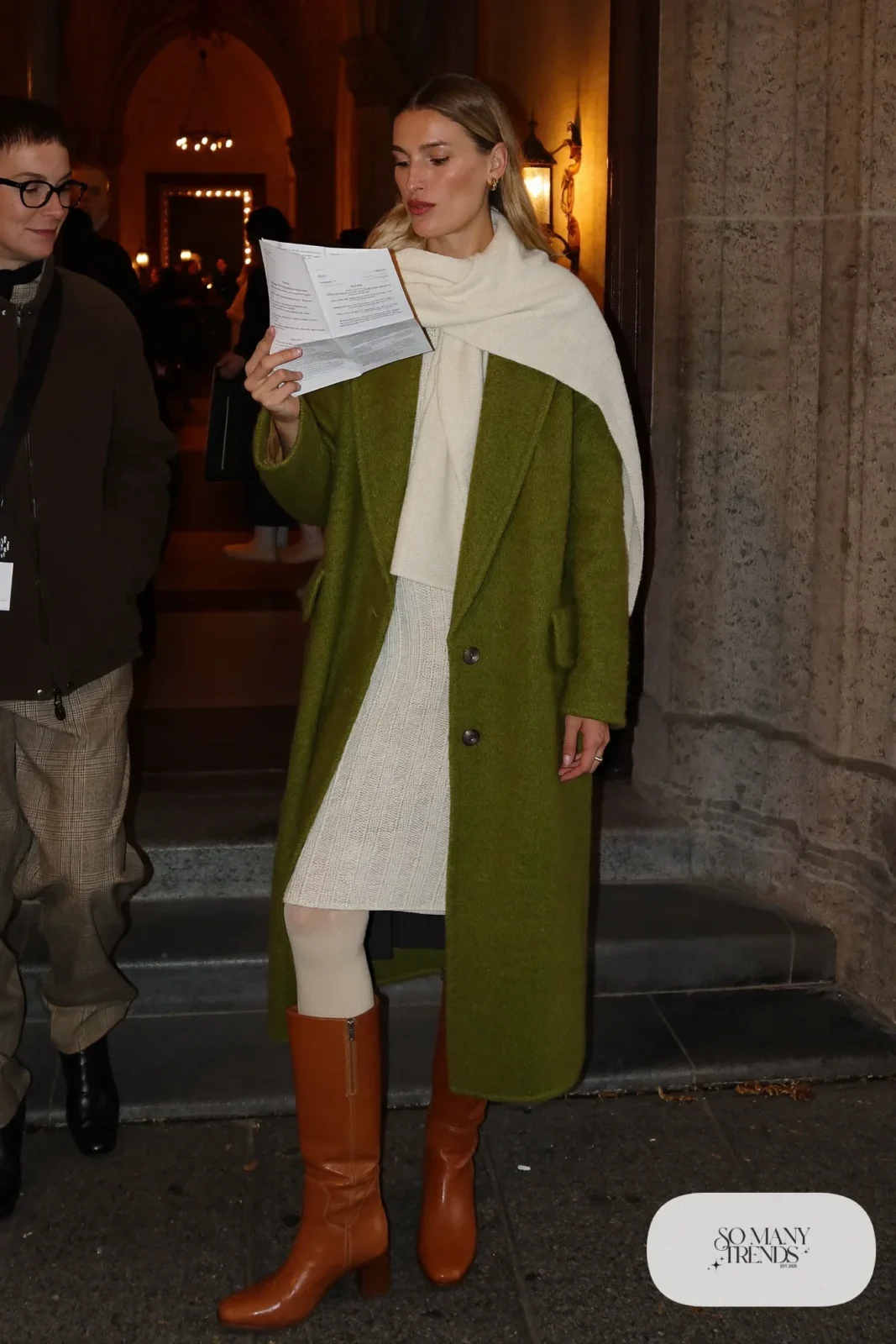 Woman in a cream knit midi sweater dress, long moss green cardigan coat, and cognac low boots, outfit 6