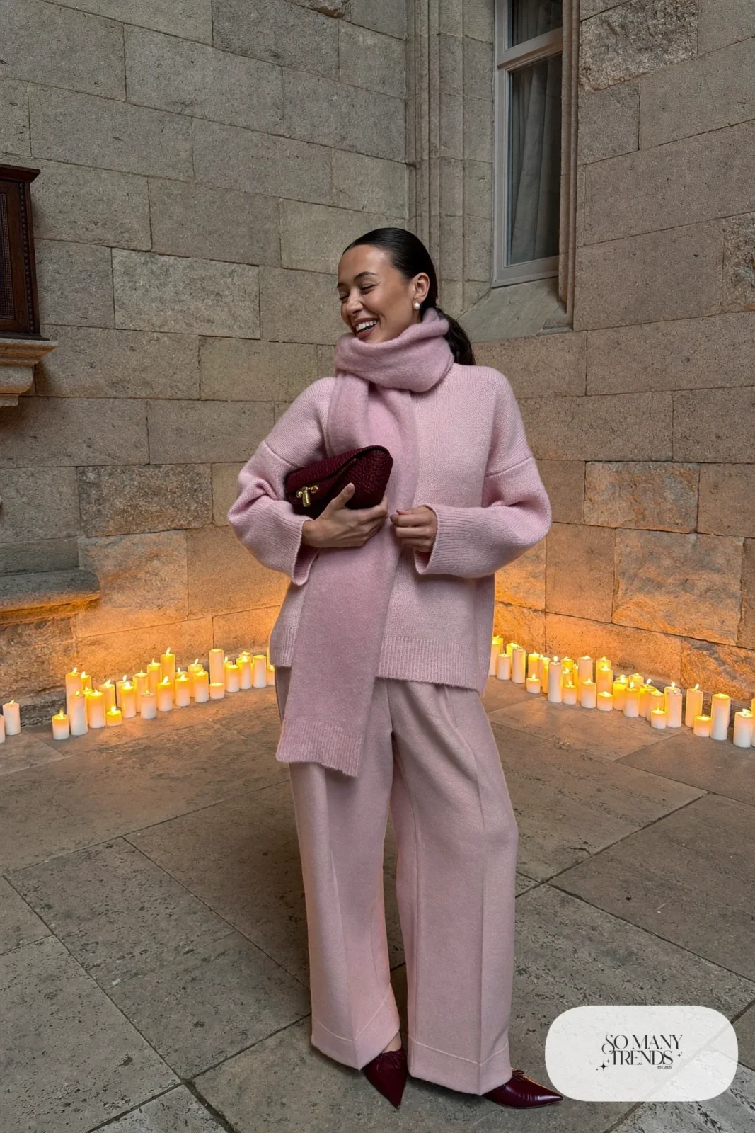Woman in a pale pink oversized sweater, matching scarf, blush wide-leg pants and burgundy flats, outfit 20