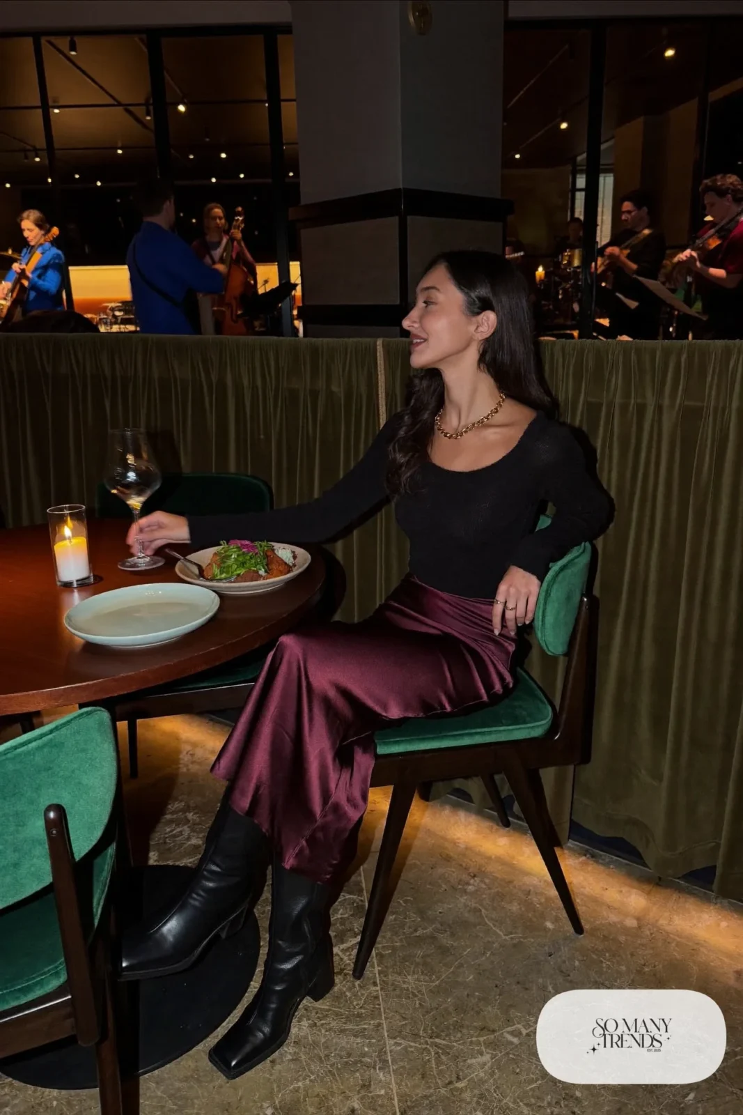 Oxblood satin midi skirt with black merino knit tucked in and black knee-high boots, outfit 3