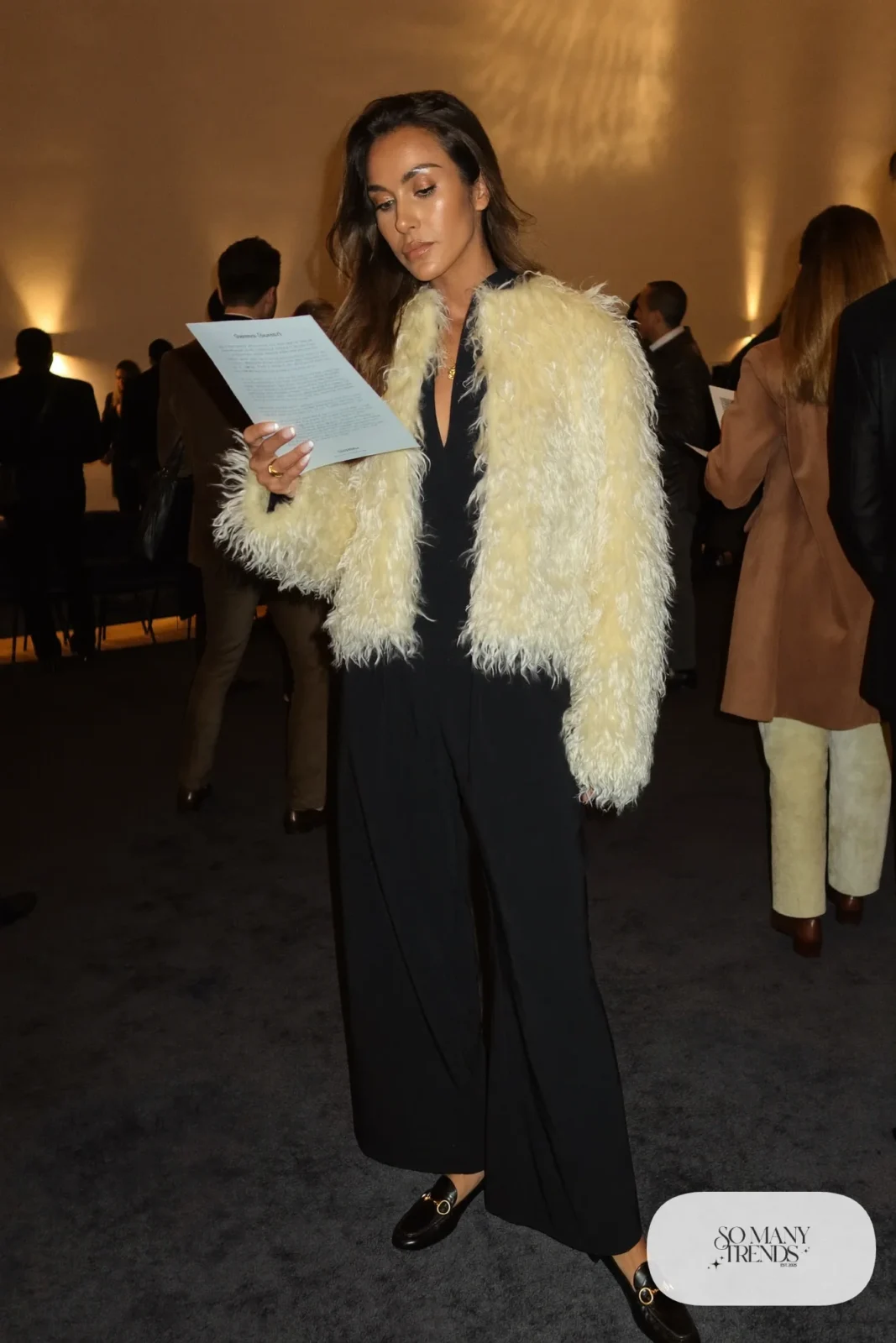 Black crepe wide-leg jumpsuit with cropped cream faux shearling jacket and black heeled loafers, outfit 5