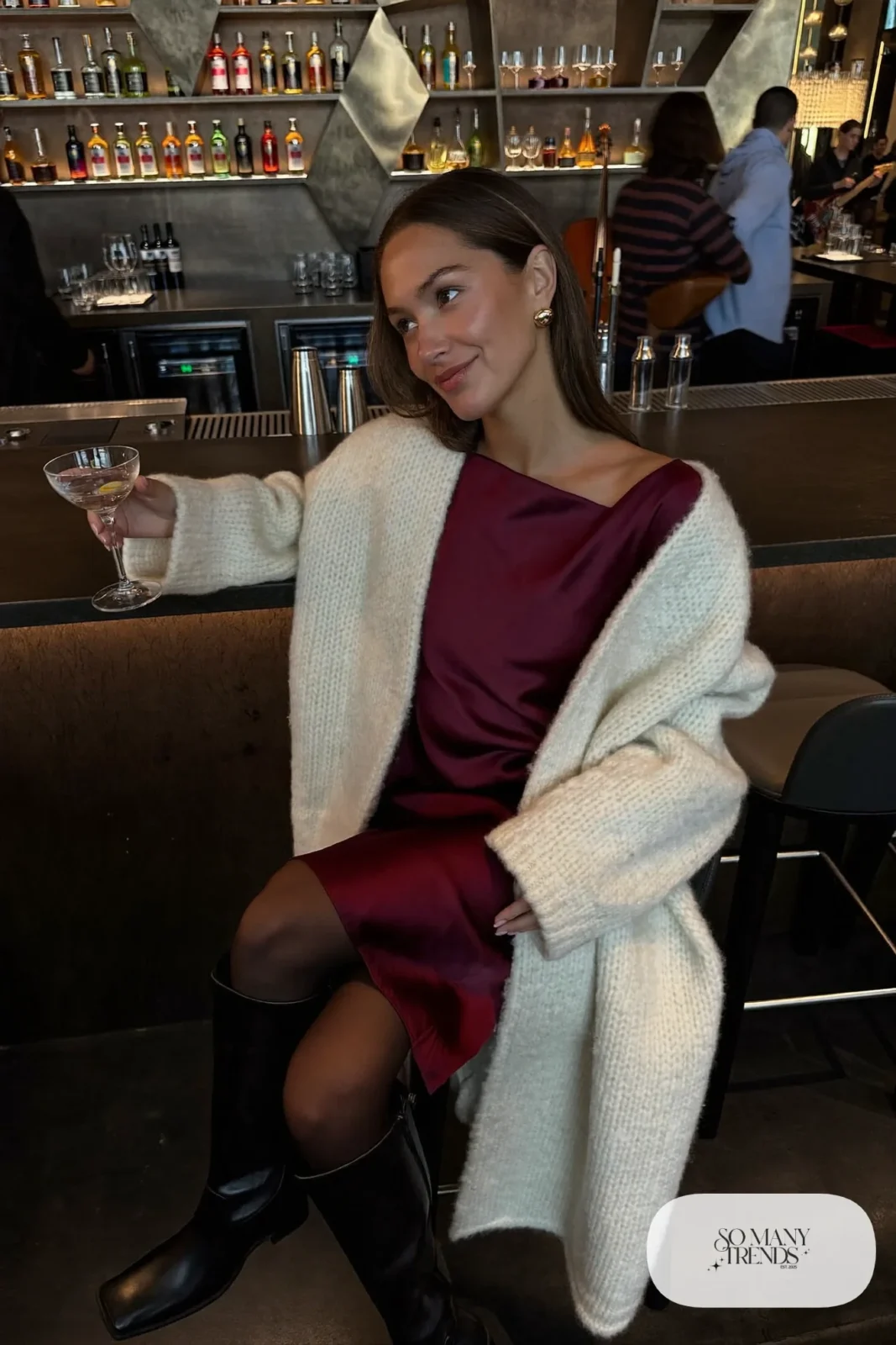 Oxblood satin slip dress with ivory chunky knit coat, sheer black tights and black boots, outfit 21