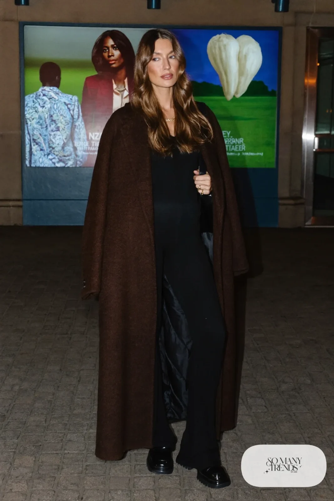 Chocolate brown long wool coat over black knit jumpsuit with black loafers, outfit 25