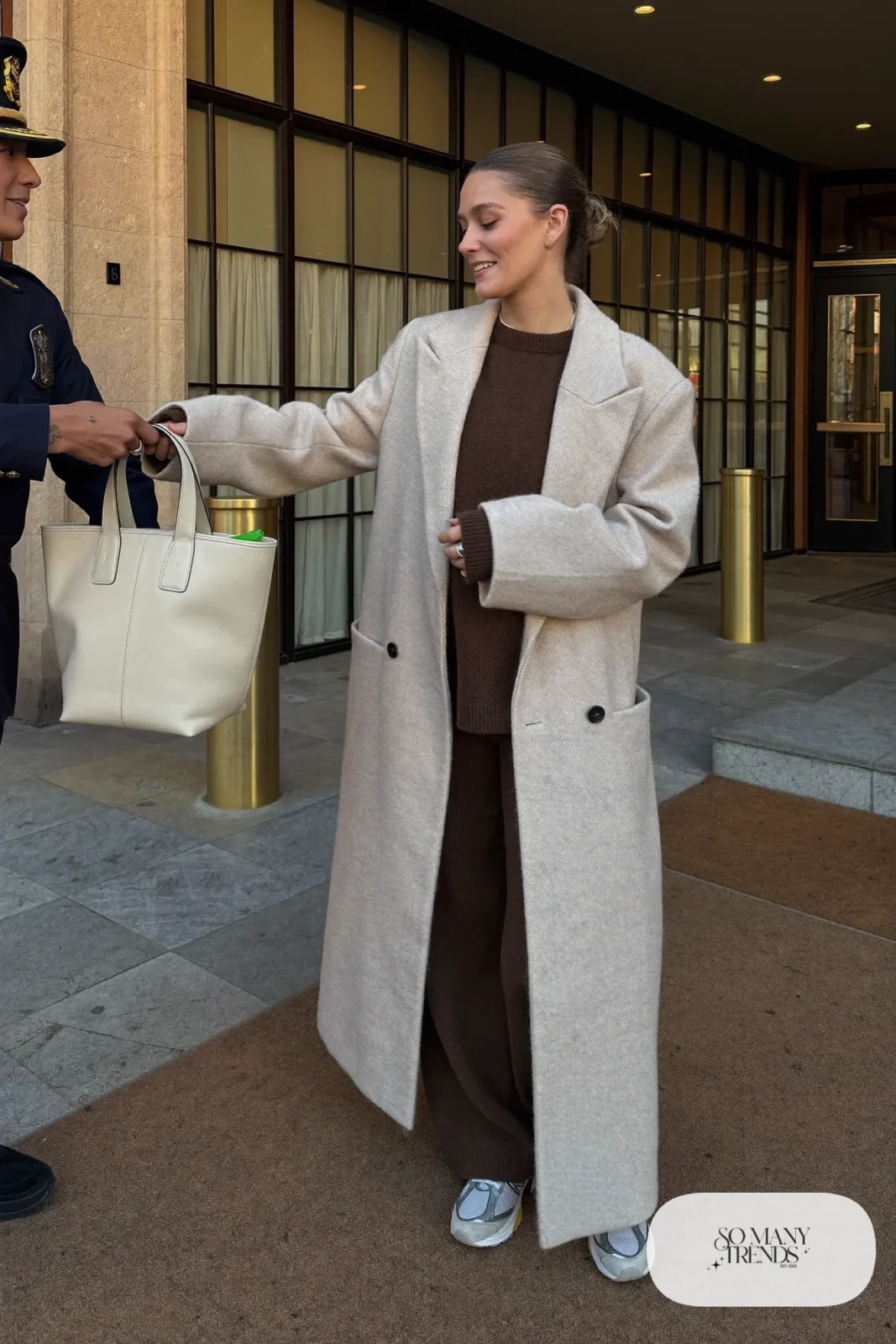 Woman in brown knit two-piece set, cream long coat and gray New Balance 9060 sneakers, outfit 24