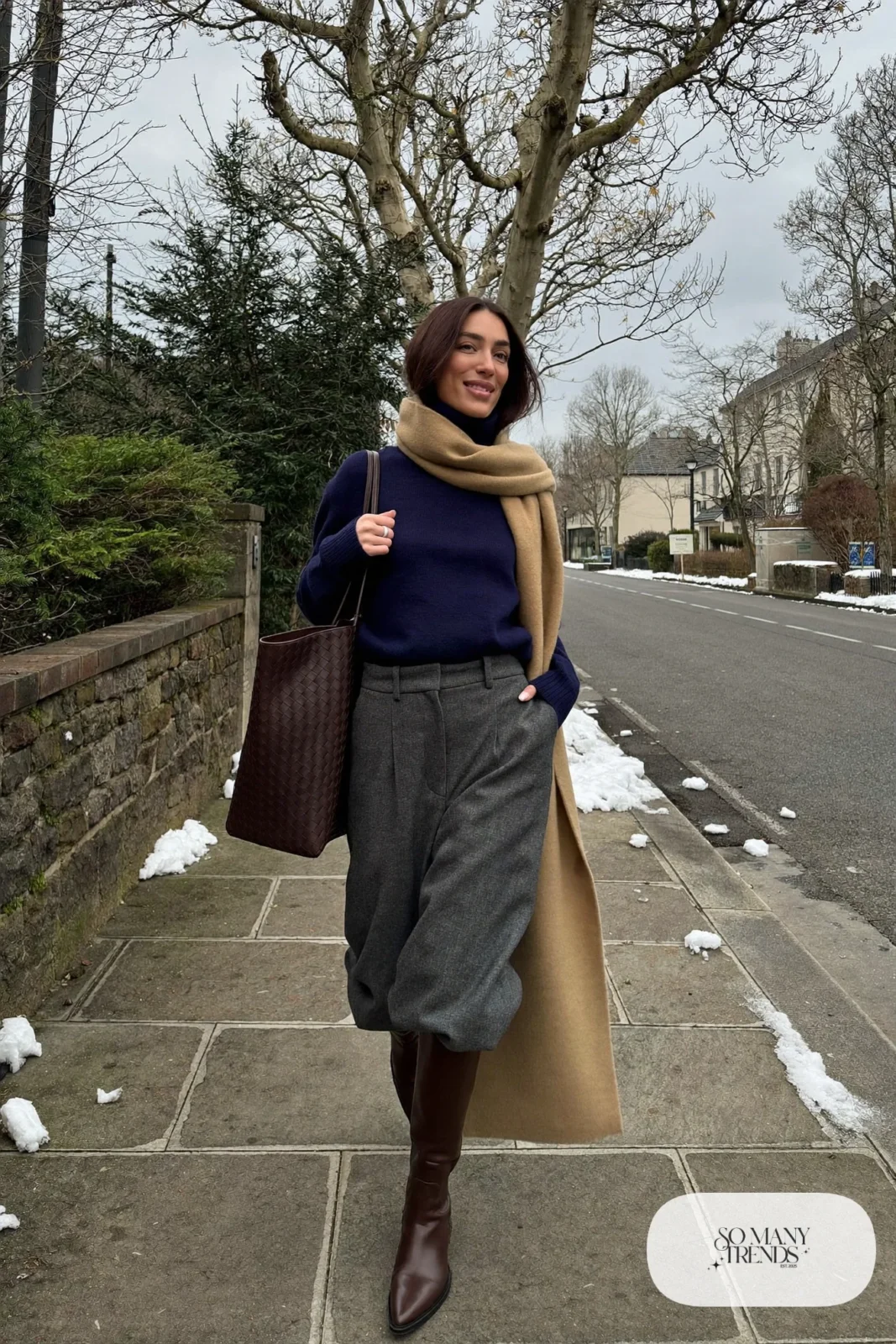 Woman in ink blue turtleneck, wide-leg gray wool pants and chocolate brown riding boots with camel scarf, outfit 4