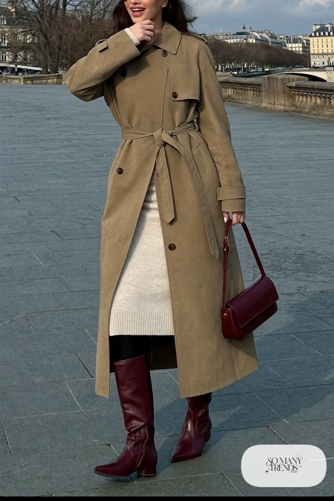 Woman in long khaki trench, cream knit dress and burgundy tall leather boots, outfit 5