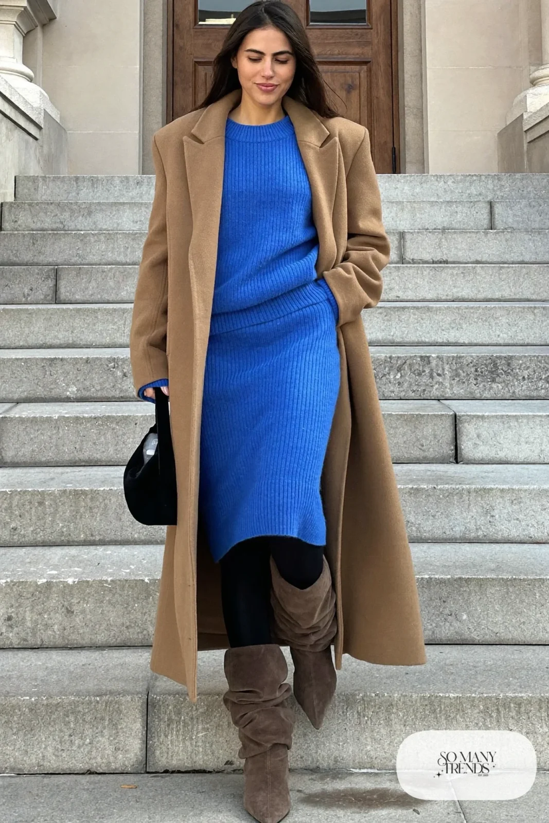 Woman in cobalt knit sweater and midi skirt set, camel coat and taupe slouchy suede boots, outfit 9