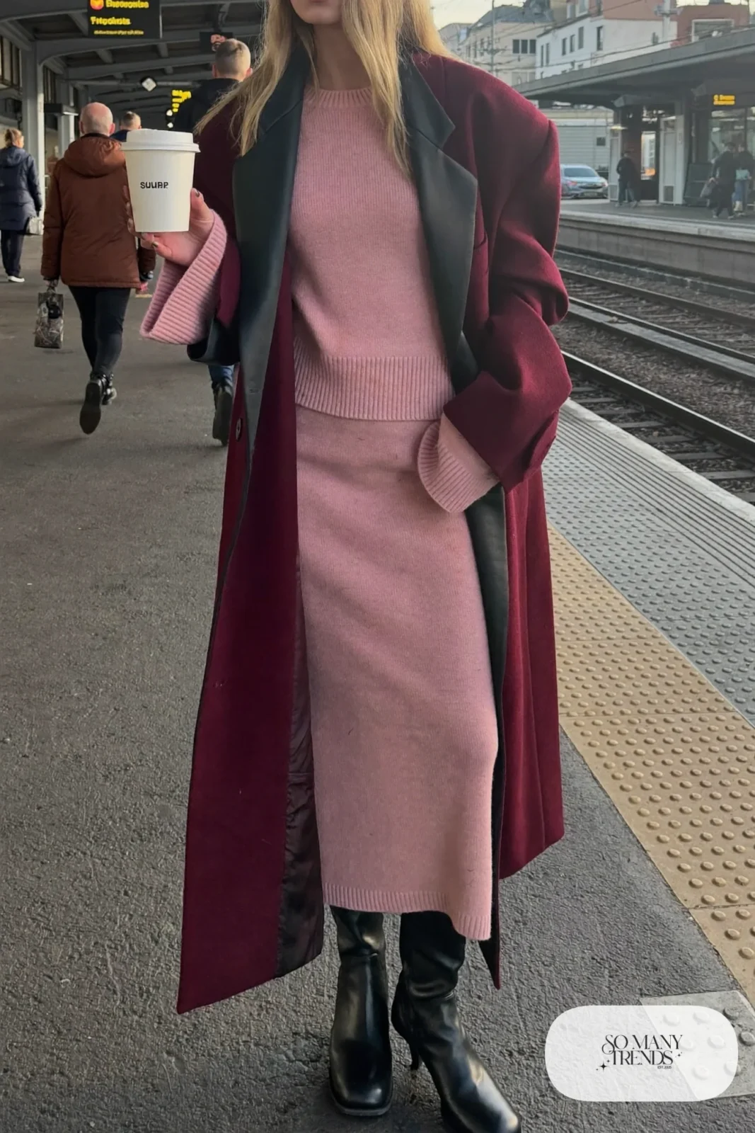 Woman in long burgundy coat, blush knit sweater and matching knit midi skirt with black tall boots, outfit 8