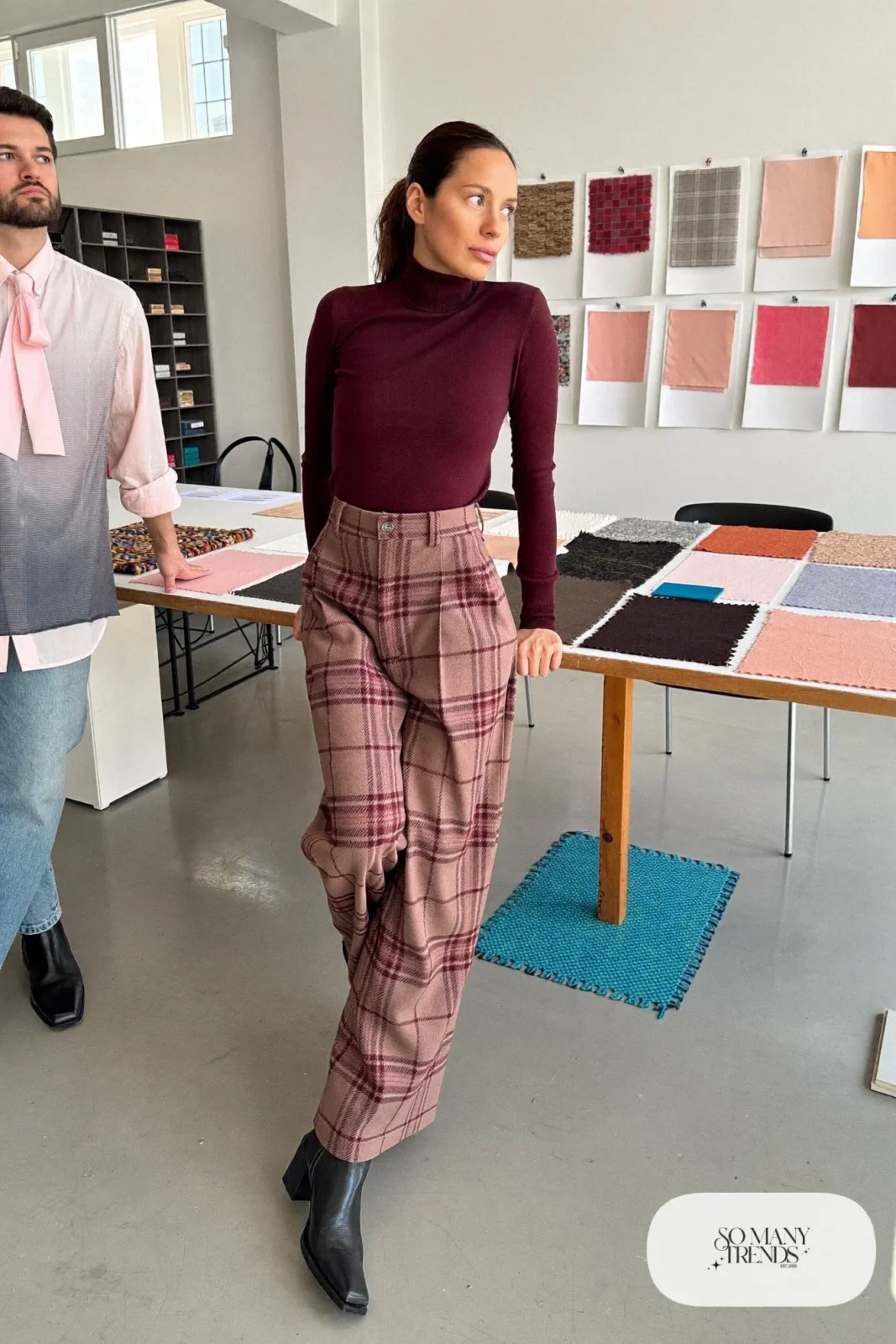 Woman in burgundy turtleneck, pink and gray plaid wide-leg pants and black ankle boots, outfit 25