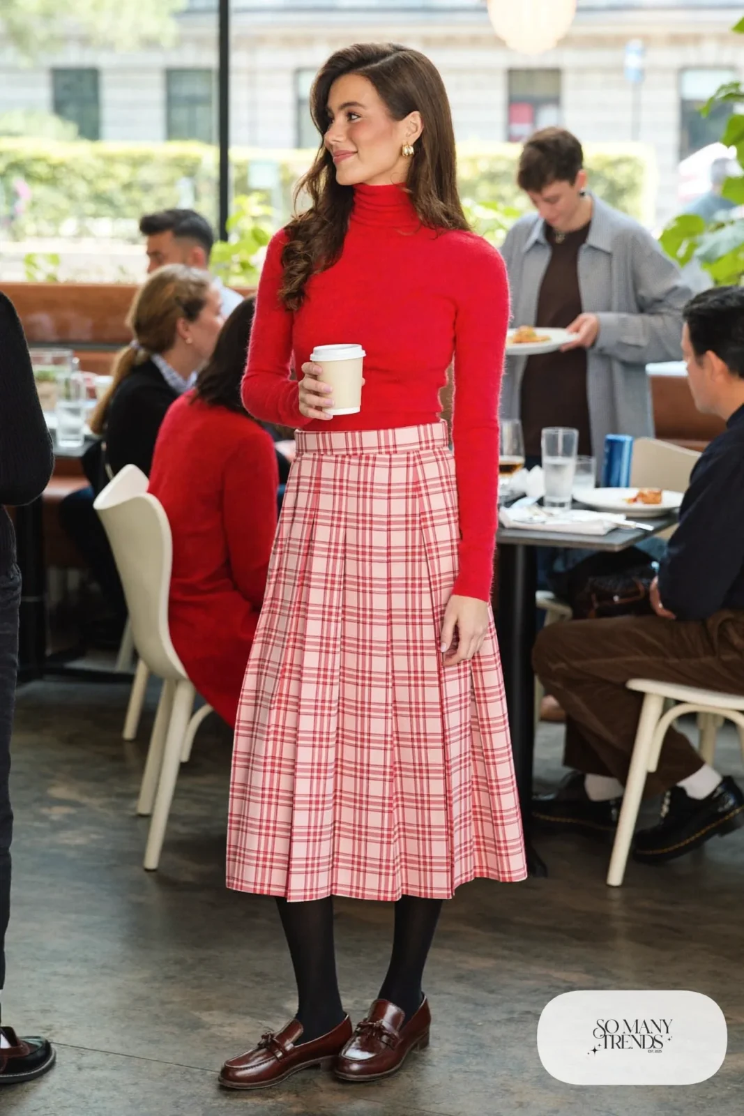 Woman in a red cashmere turtleneck, pink plaid pleated midi skirt, black tights and brown loafers, outfit 15