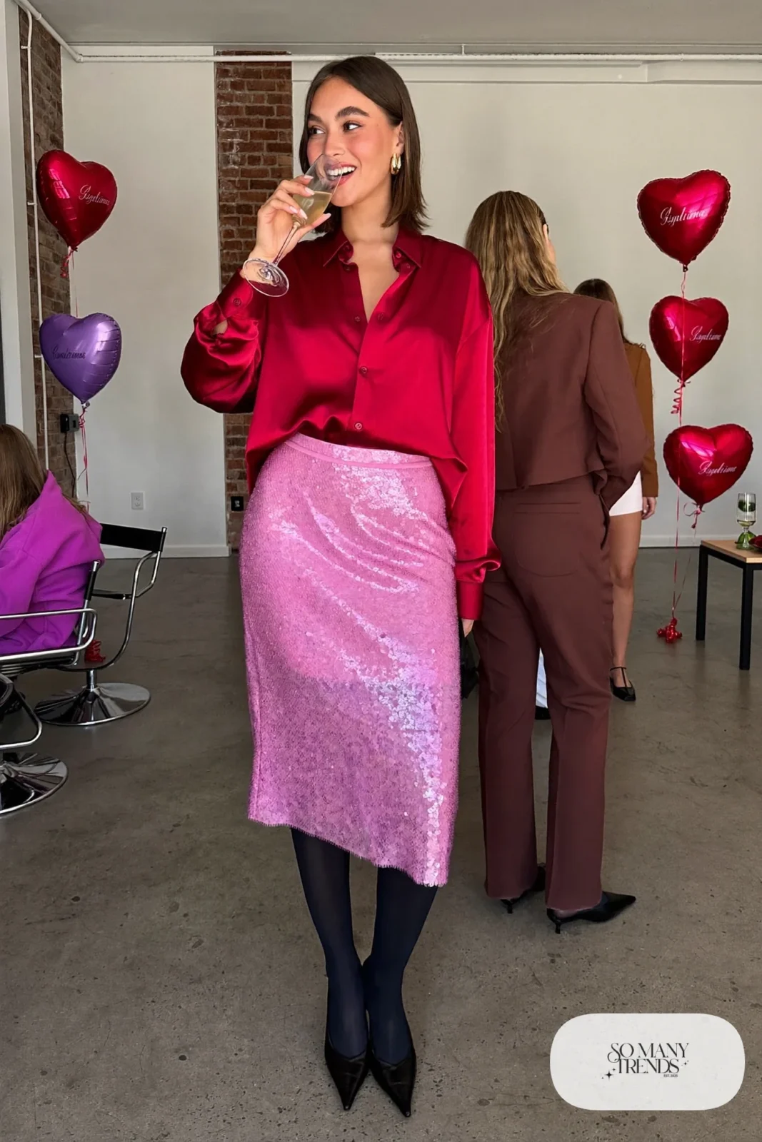 Woman in a red satin shirt, pink sequin midi skirt, sheer tights and black pointed pumps, outfit 32