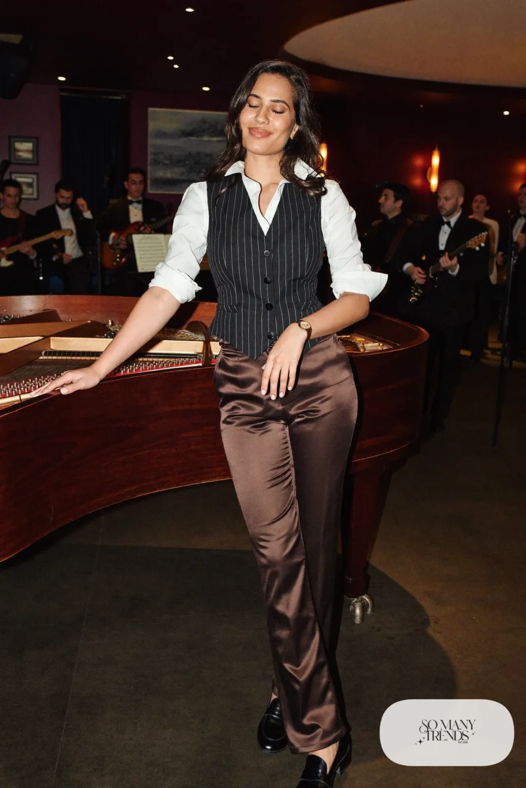 Black pinstripe tailored vest over white shirt with chocolate brown satin pants and black loafers, outfit 11