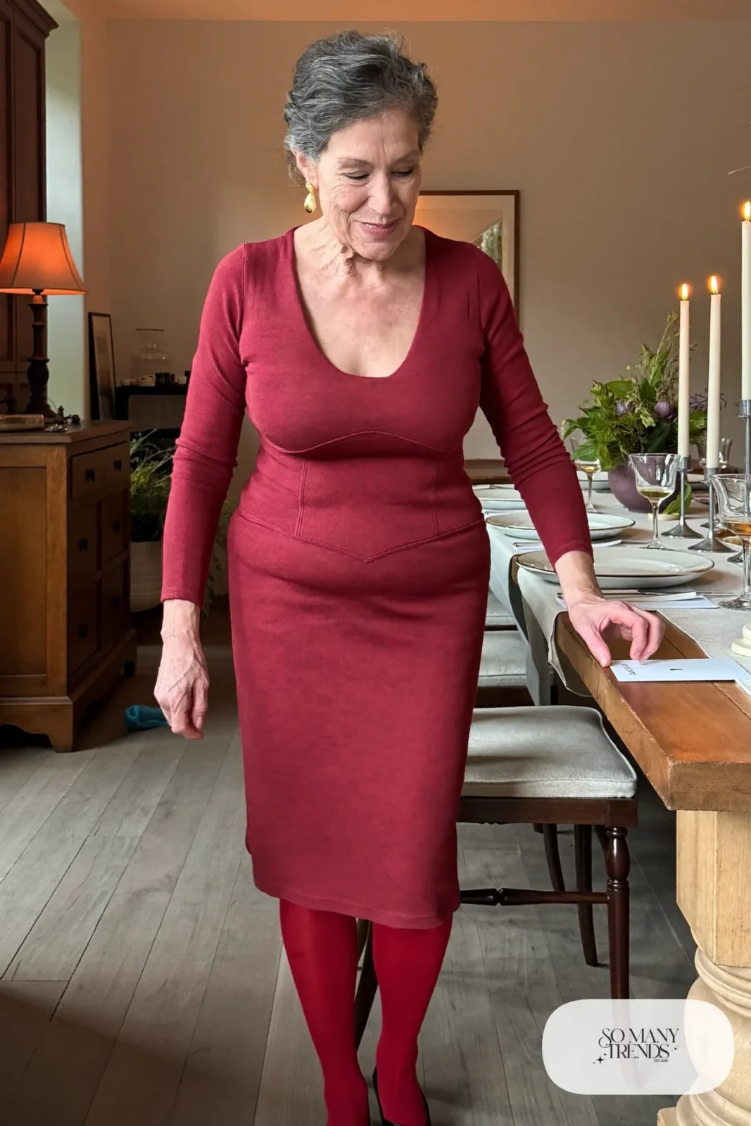 Petite woman in a burgundy knit V-neck midi dress with burgundy tights and low heels, outfit 8