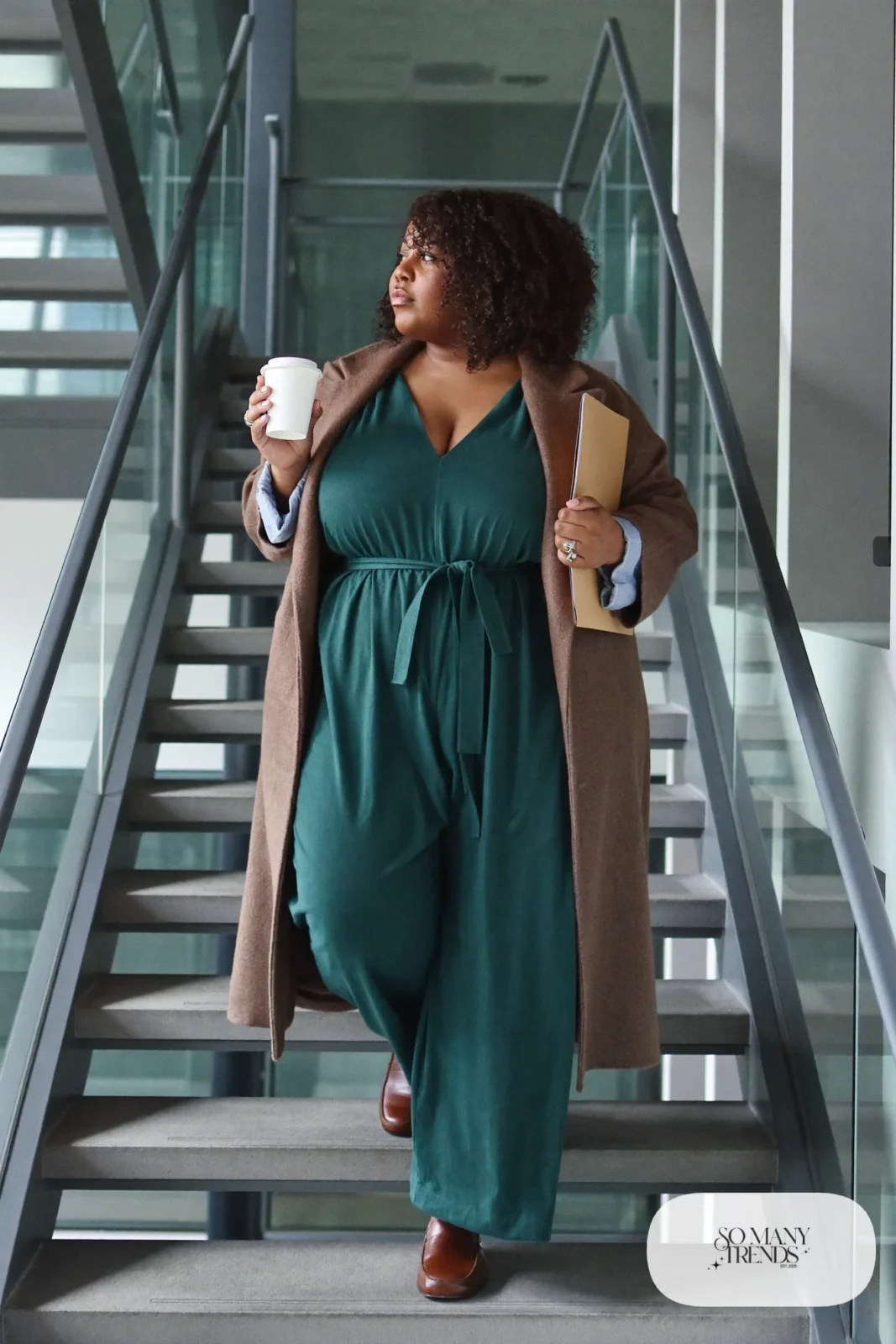 Woman in teal crepe wide-leg jumpsuit, knee-length oatmeal wool coat and cognac loafers, outfit 20