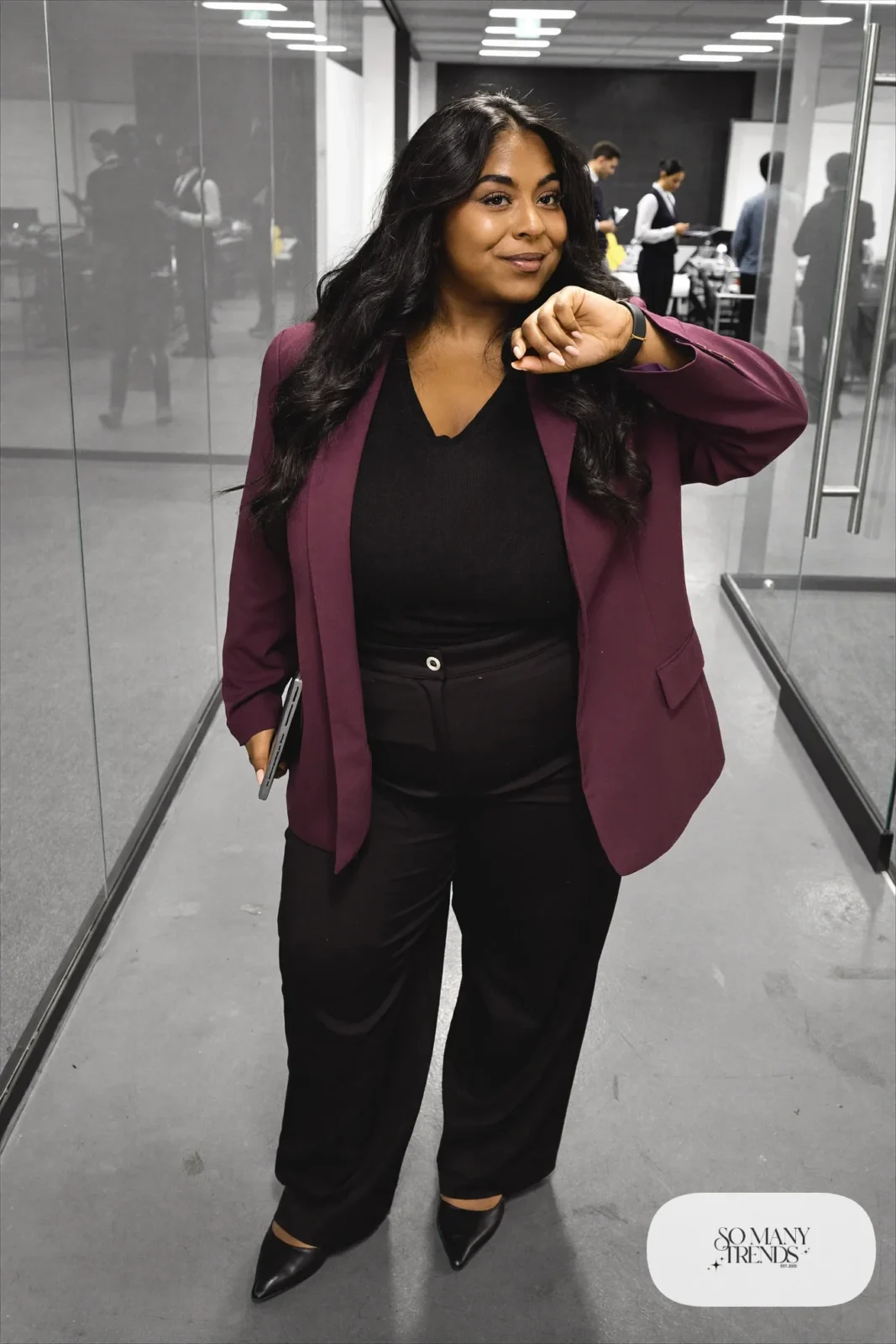 Woman in plum relaxed blazer, black V-neck knit, black wide-leg pants and black pointed flats, outfit 23