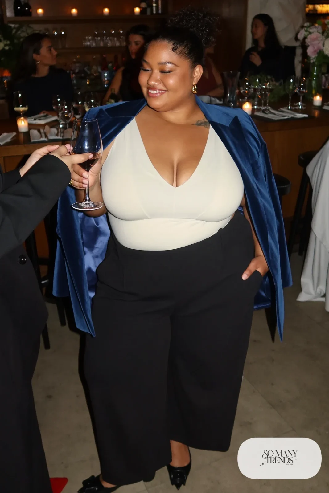 Woman in navy velvet blazer, cream V-neck top, black wide-leg pants, pointed flats and gold hoops, outfit 31