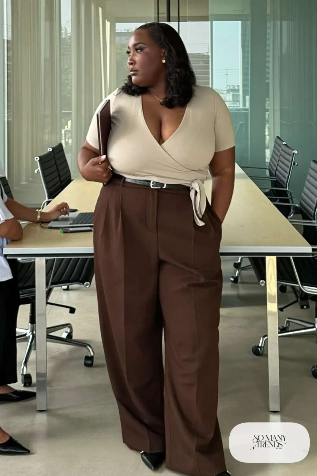 Woman in an oatmeal wrap top with espresso wide-leg pants and pointed flats, outfit 8