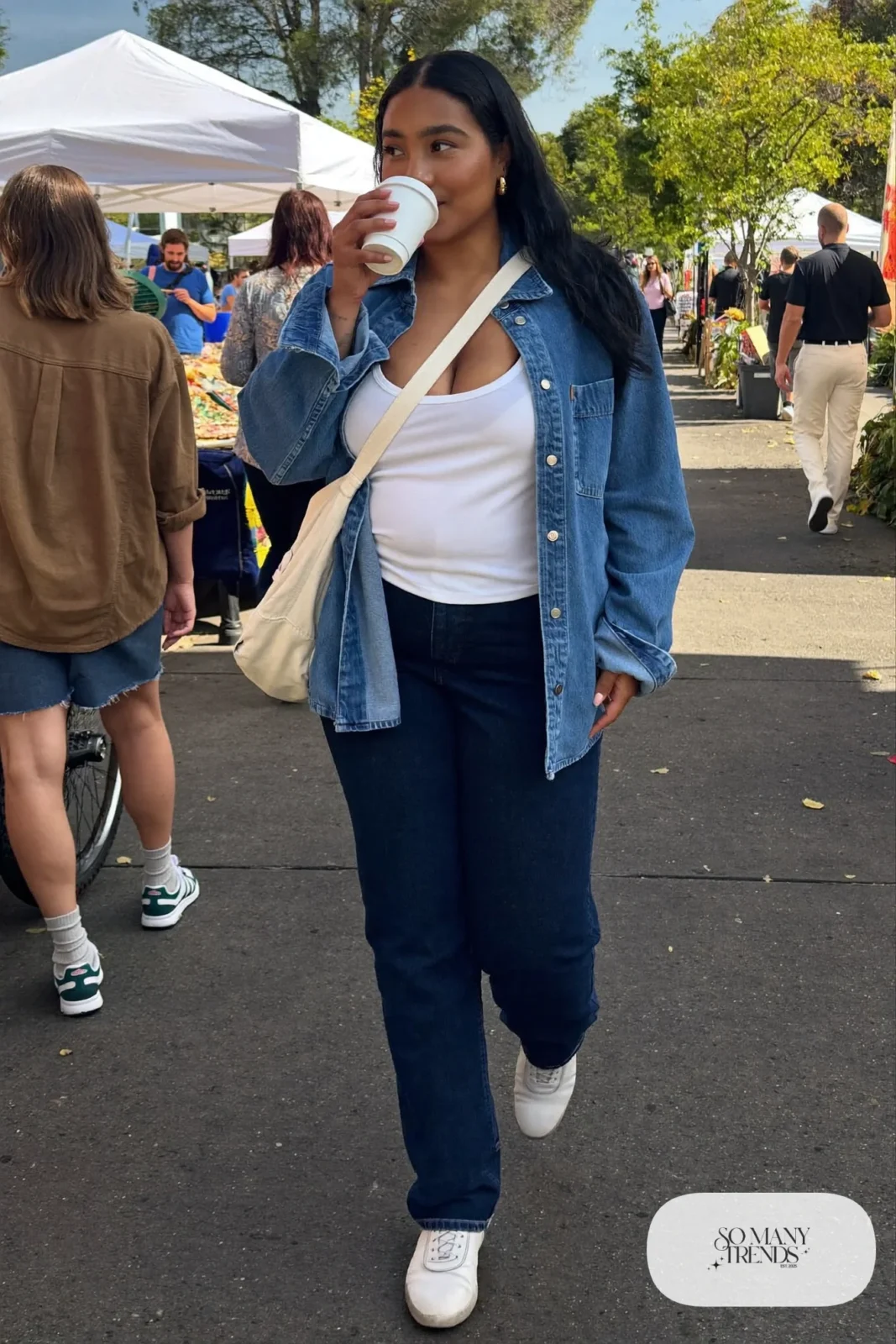 Woman in a denim shirt jacket worn open over a white scoop tee, dark jeans and white sneakers, outfit 13
