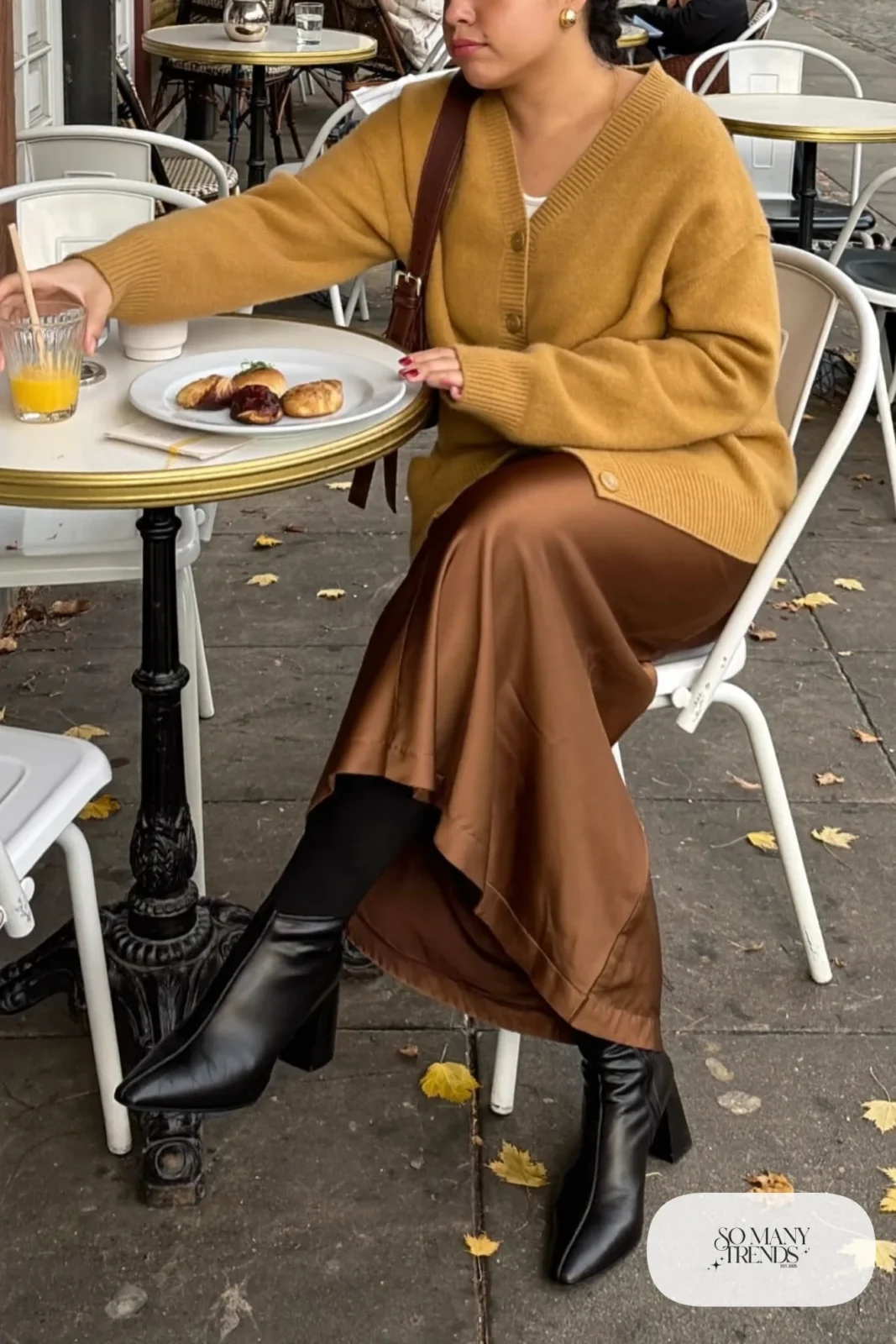 Woman in a mustard V-neck cardigan with an espresso satin slip skirt and block heel boots, outfit 14