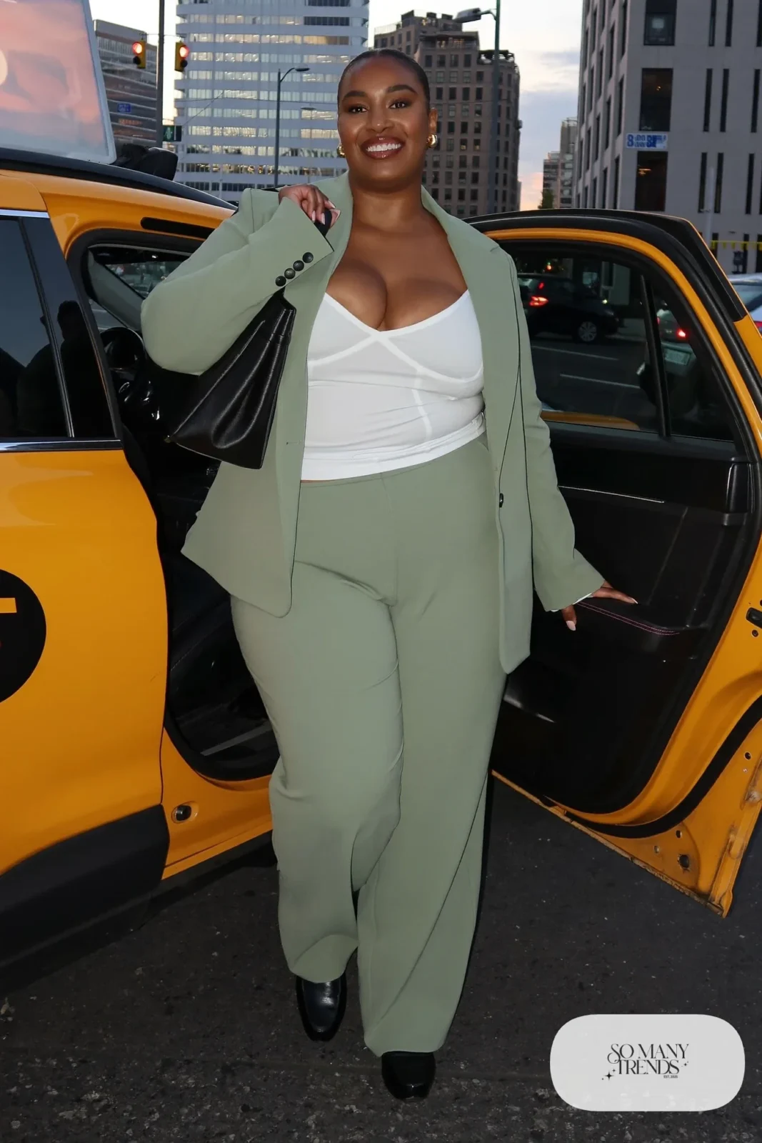 Woman in a relaxed sage blazer and matching pants with a camisole and loafers, outfit 24