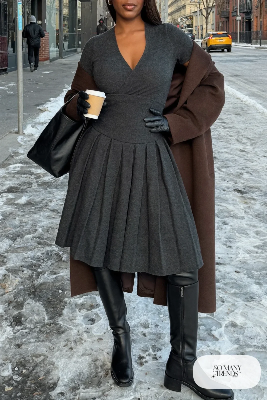Woman in a charcoal paneled knit midi dress with a long coat and tall boots, outfit 25