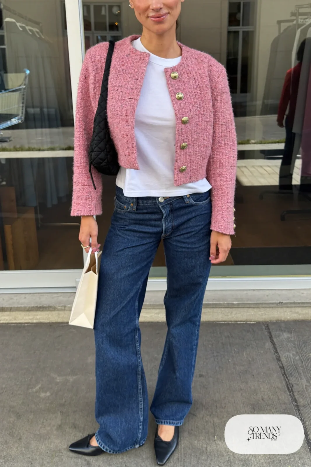 Woman in dark indigo jeans, dusty pink tweed jacket, white tee and black flats, look 14