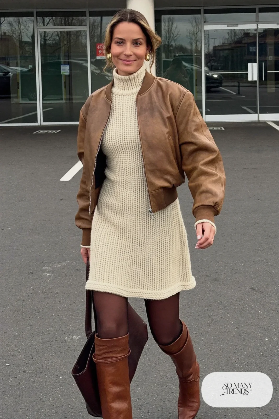 Woman in a cream ribbed knit midi dress, brown leather bomber jacket and tall brown boots, outfit 18