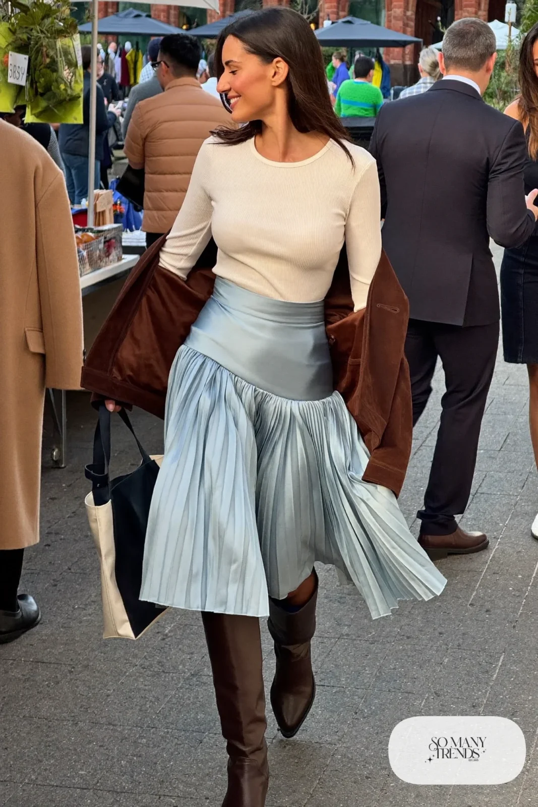 Woman with a straight athletic figure in a fitted cream knit top, a baby blue pleated midi skirt and brown boots, outfit 16