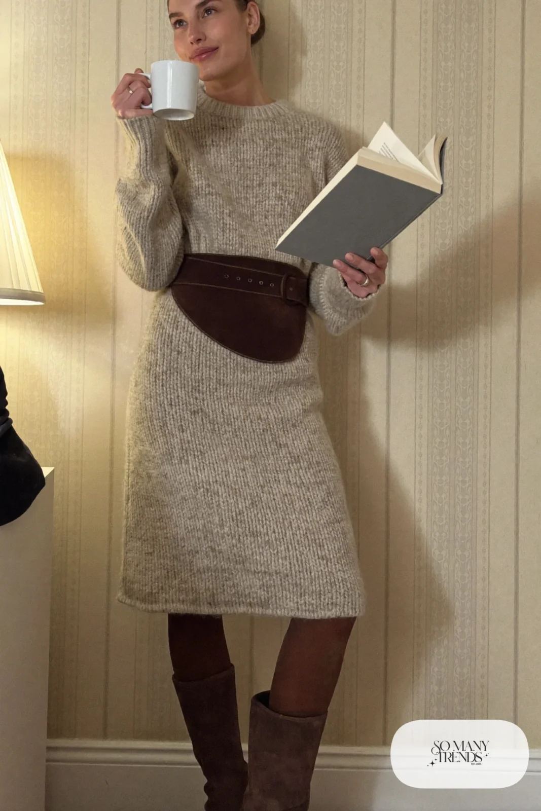 Woman with a straight athletic figure in an oatmeal sweater dress with a wide brown obi belt, opaque tights and tall boots, outfit 26