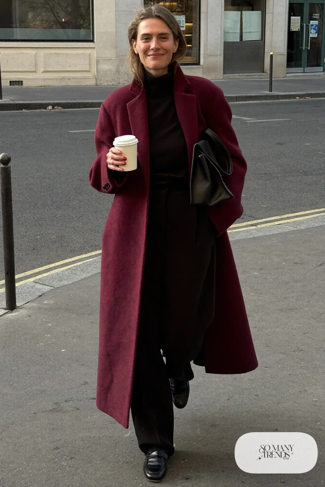 Woman in a long wine wool cocoon coat, black turtleneck, black straight pants and black loafers, outfit 1