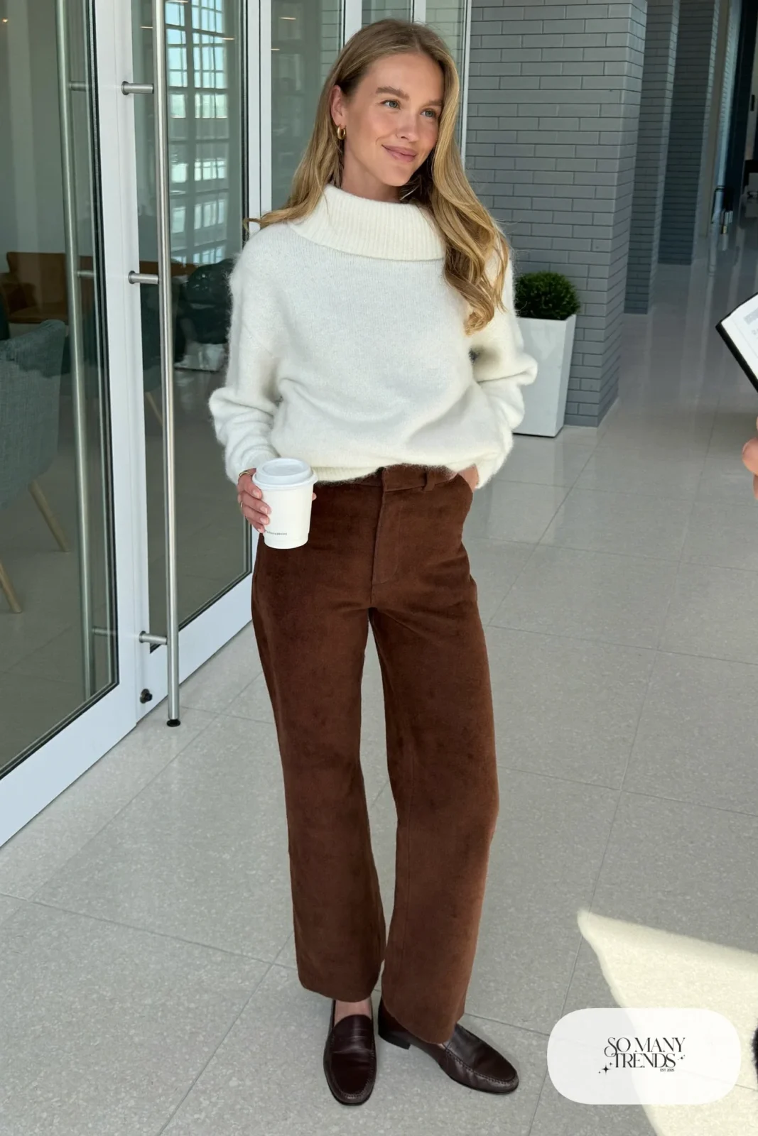 Woman with pear-shaped figure in a white boat-neck sweater, espresso straight-leg pants and brown loafers, outfit 1