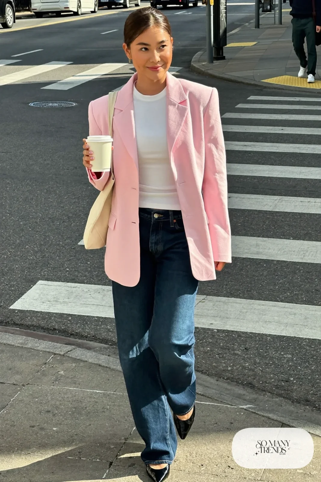Woman with pear-shaped figure in a pale pink blazer, white tee, dark straight-leg jeans and pointed flats, outfit 2