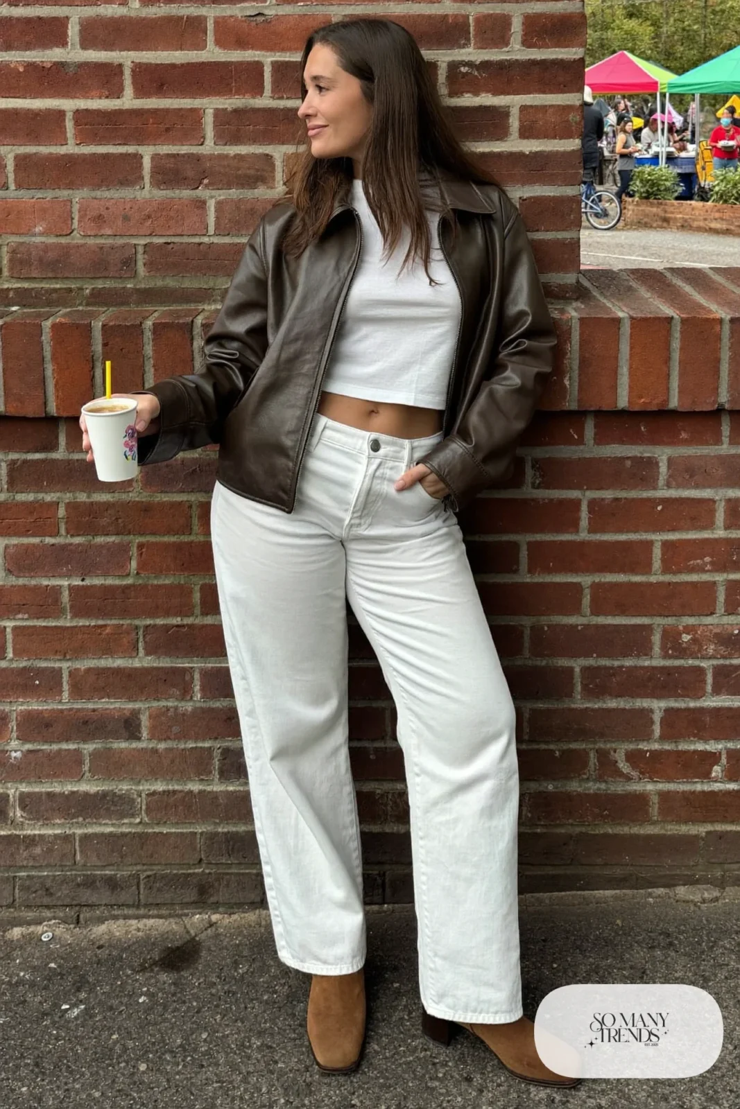 Woman with pear-shaped figure in a cropped espresso leather jacket, white tee, white straight jeans and brown boots, outfit 12